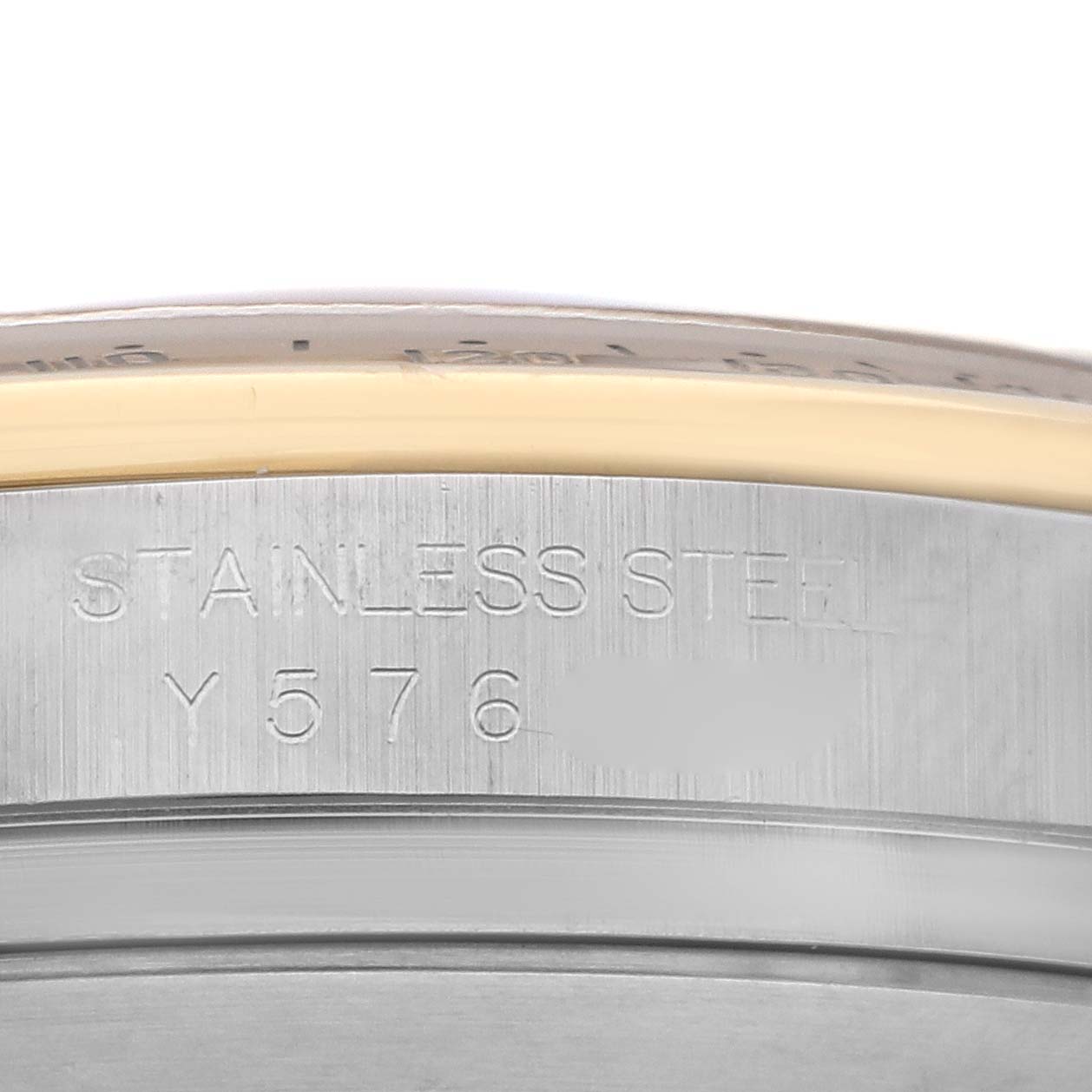 The image shows a close-up of the outer edge and engravings on the bezel of a Rolex Daytona 116523 Men's Steel and Gold (two tone) Black Dial 116523 Men's Steel and Gold (two tone) Black Dial watch.