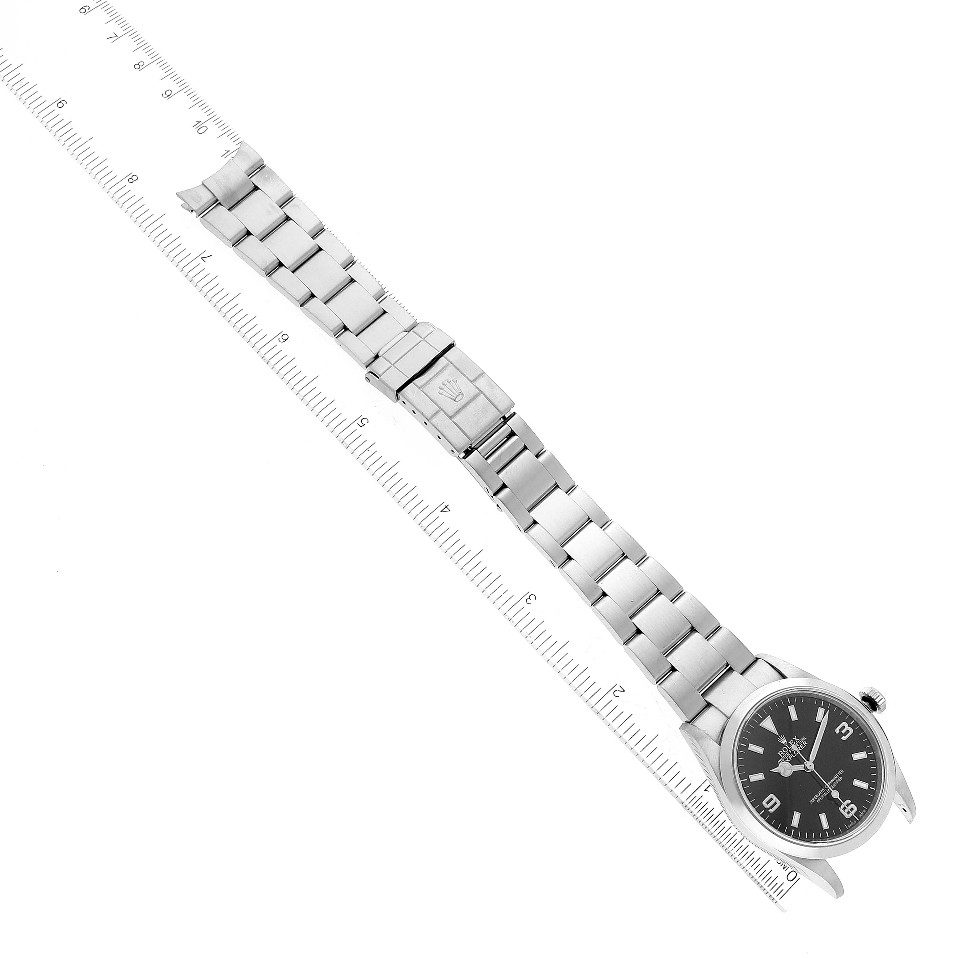 The image shows a Rolex Explorer 114270 Men's Stainless Steel Black Dial 114270 Men's Stainless Steel Black Dial watch laid flat with its bracelet fully extended and a ruler measuring its length.