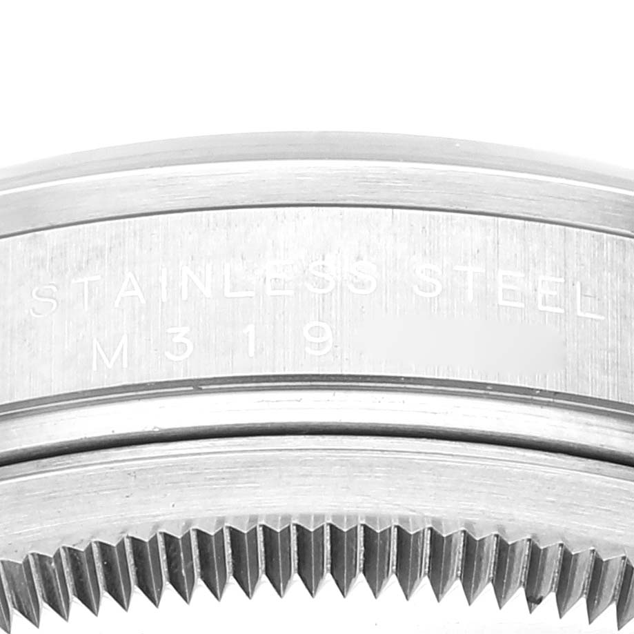 The image shows a close-up of the stainless steel case back and edge of the bezel of a Rolex Explorer 114270 Men's Stainless Steel Black Dial 114270 Men's Stainless Steel Black Dial watch.