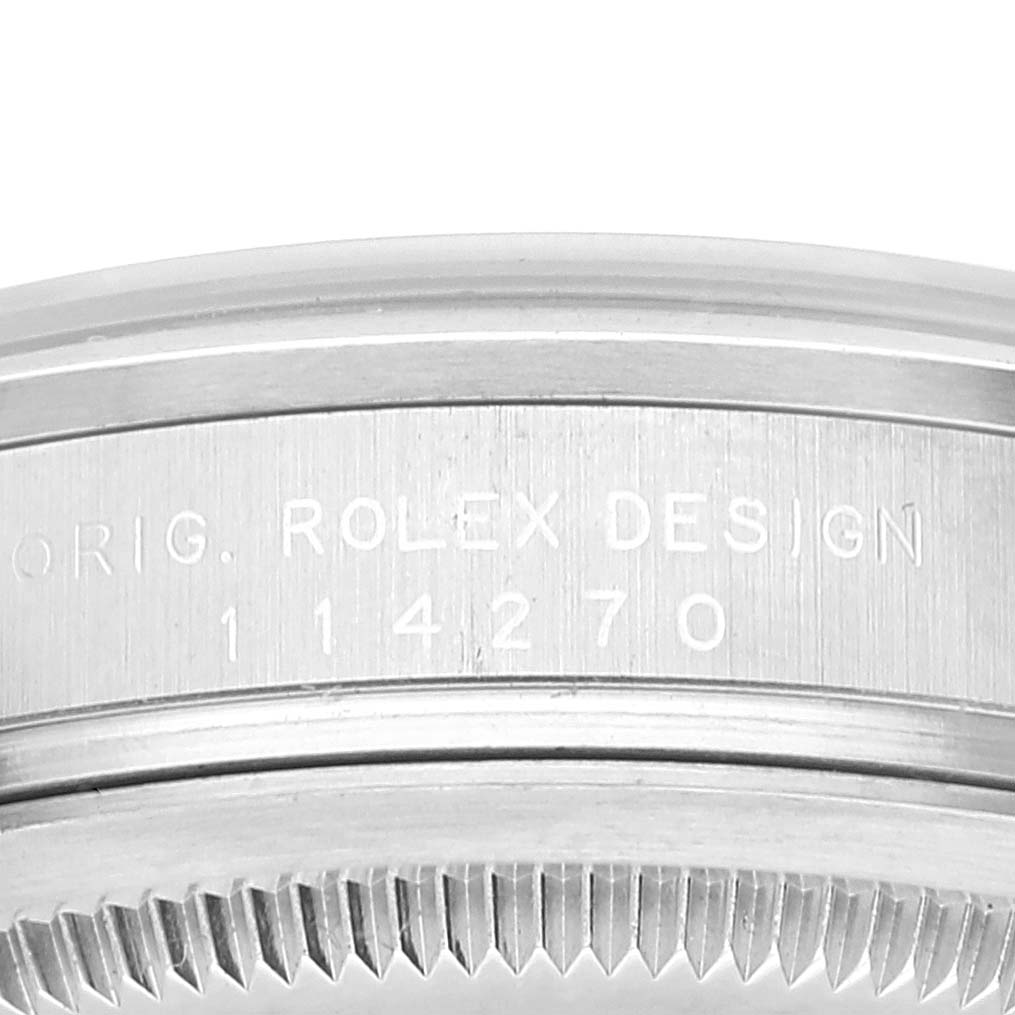 This close-up shows the side of the case and part of the bezel for the Rolex Explorer 114270 Men's Stainless Steel Black Dial 114270 Men's Stainless Steel Black Dial model, with engraving details visible.