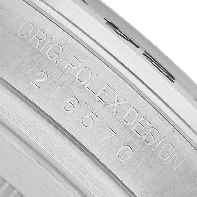 The image shows a close-up of the engraved inner bezel on a Rolex Explorer 216570 Men's Stainless Steel Black Dial watch.