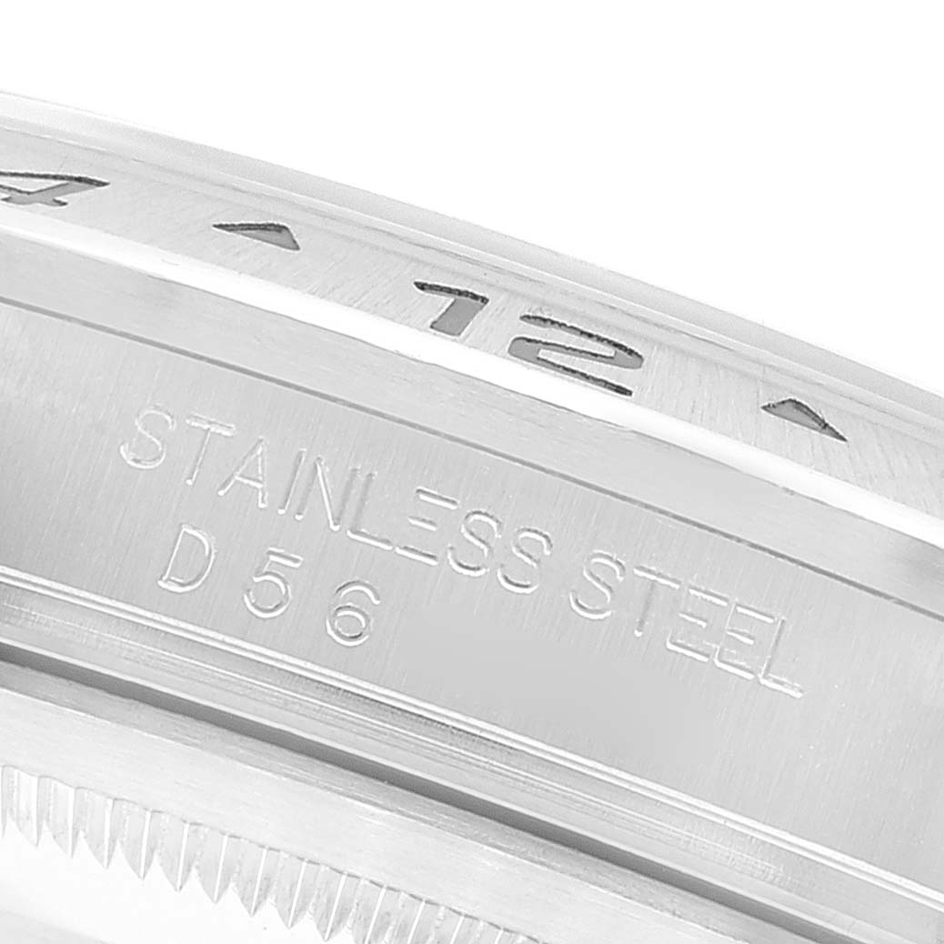 The image shows the side view of the bezel and case of a Rolex Explorer 16570 Men
s Stainless Steel Black Dial 16570 Men
s Stainless Steel Black Dial watch, highlighting "STAINLESS STEEL" engraving.