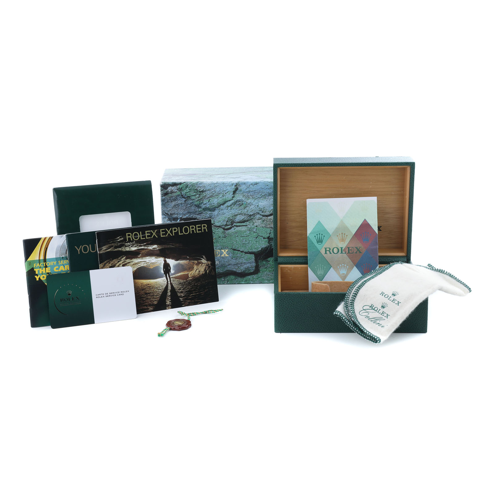 The image shows the accessories for a Rolex Explorer 16570 Men's Stainless Steel White Dial, including the box, booklet, tags, and a cleaning cloth.