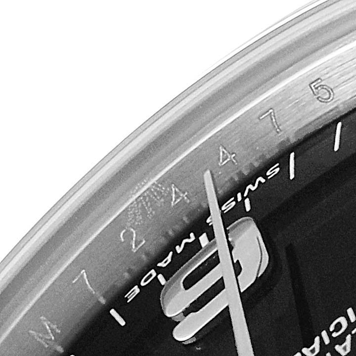 The image shows a close-up view of the dial and bezel, specifically the 2 to 7 hour markers, of a mid-size Rolex watch.