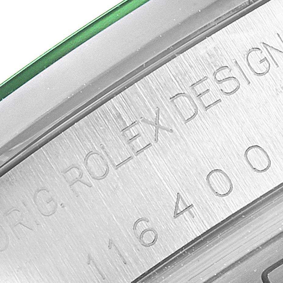 Close-up view of the Rolex Milgauss 116400GV Men's Stainless Steel Blue Dial 116400GV Men's Stainless Steel Blue Dial, showing the engraved serial number and part of the edge with a green-tinted rim.