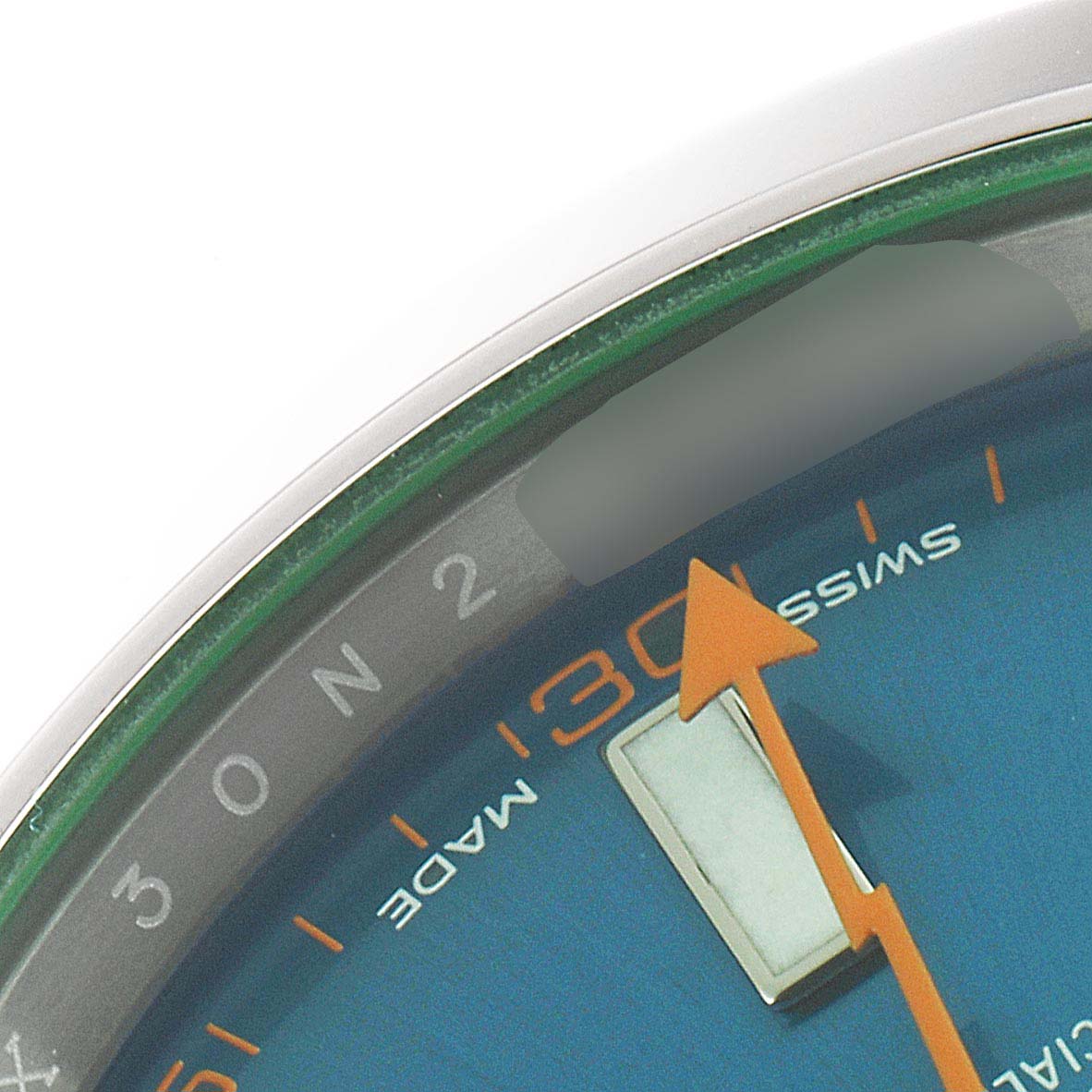 This close-up angle shows the dial and part of the case of the Rolex Milgauss 116400GV Men's Stainless Steel Blue Dial 116400GV Men's Stainless Steel Blue Dial, highlighting the orange second hand and "SWISS MADE" label.