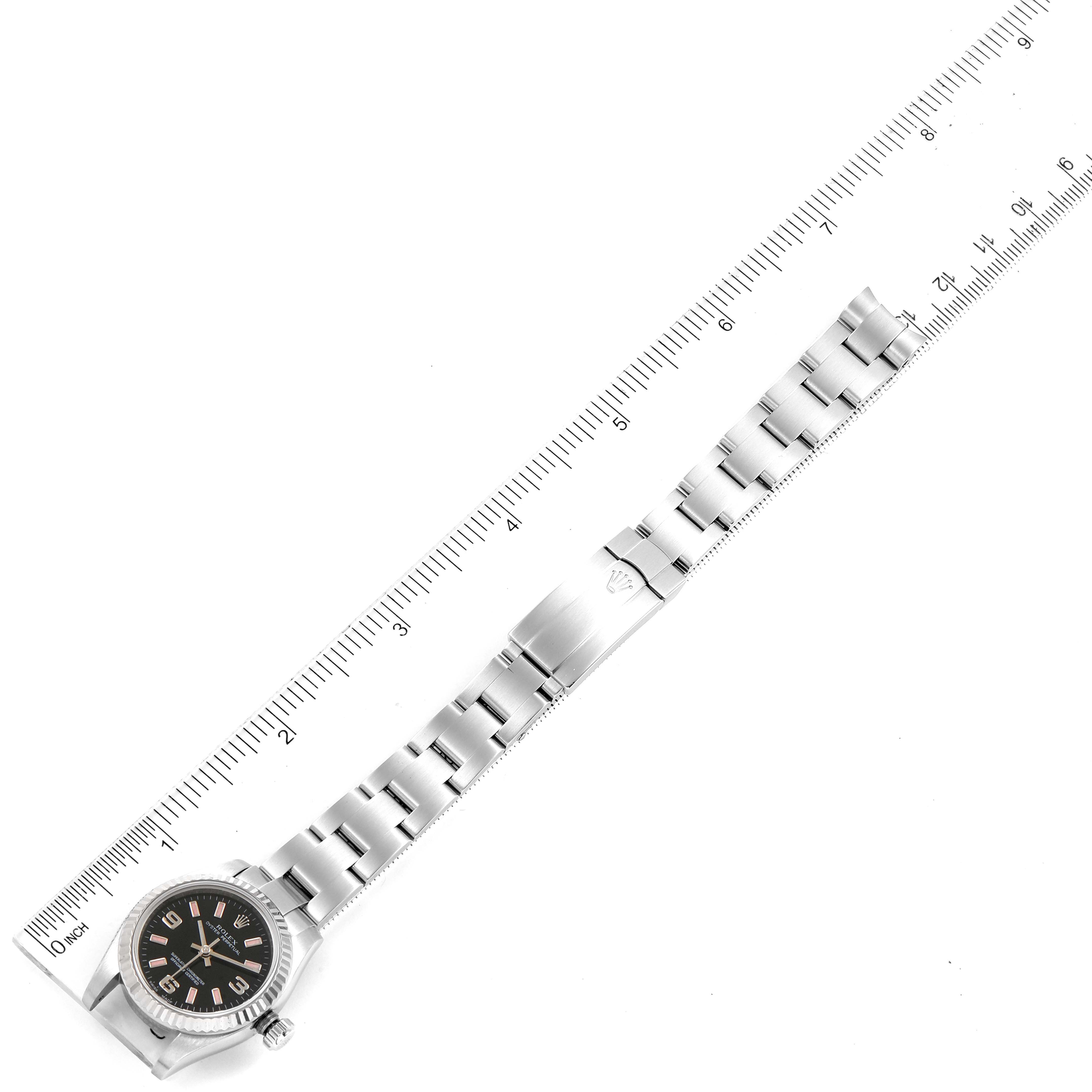 The image shows an overhead view of a Rolex Oyster Perpetual 176234 Women
s Stainless Steel Black Dial 176234 Women
s Stainless Steel Black Dial watch with a ruler for scale, highlighting the watch face and bracelet.