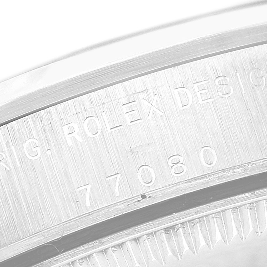 The image shows a close-up of the engraved side of the bezel on a Rolex Oyster Perpetual 77080 Women's Stainless Steel Pink Dial watch.
