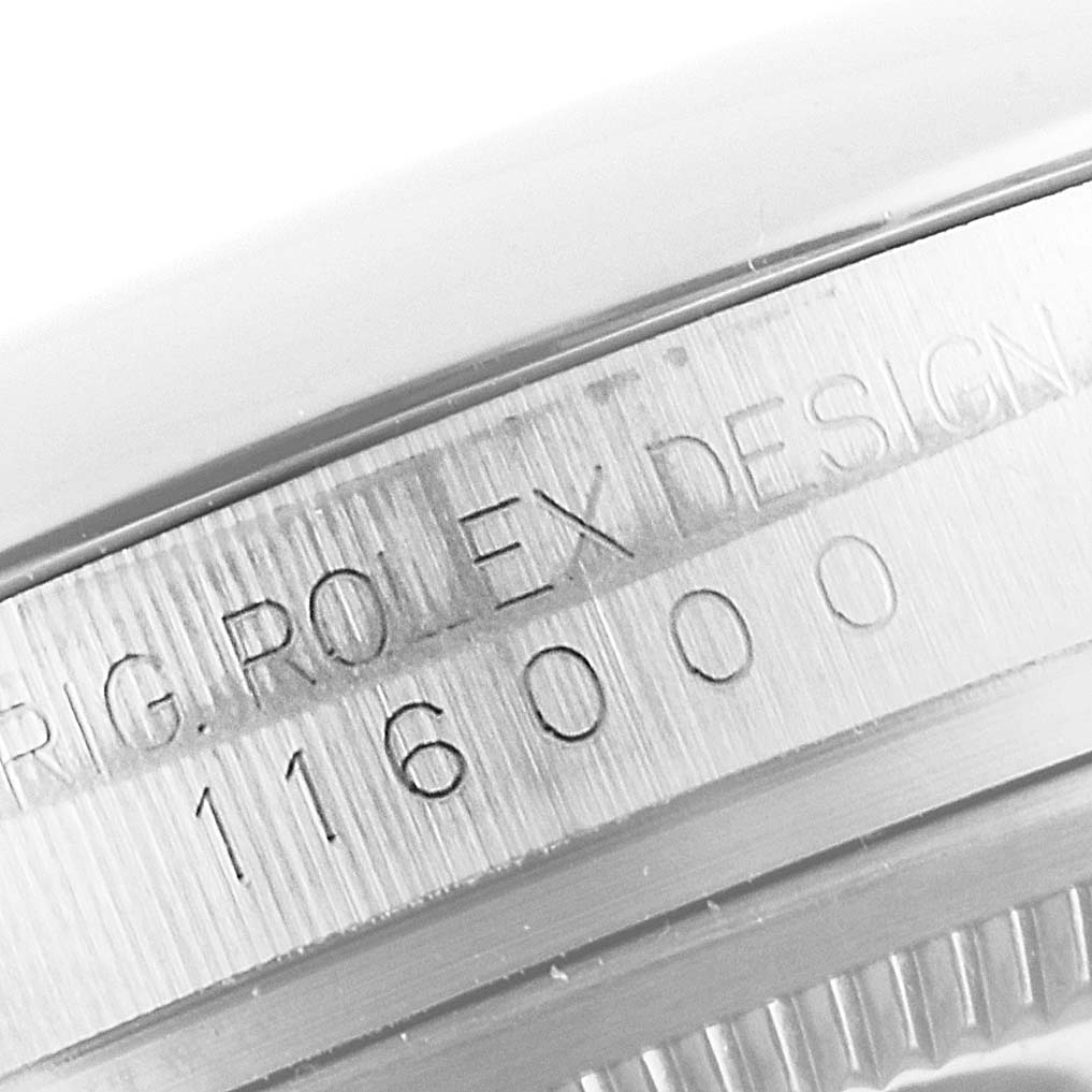This image shows a close-up of the engraved case back and model number (116000) of a Rolex Oyster Perpetual 116000 Men's Stainless Steel Burgundy Dial 116000 Men's Stainless Steel Burgundy Dial watch.