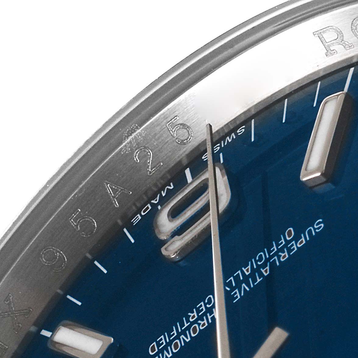 The image shows a close-up angle of the dial, bezel, and hands of a Rolex Oyster Perpetual 116000 Men
s Stainless Steel Blue Dial 116000 Men
s Stainless Steel Blue Dial watch.