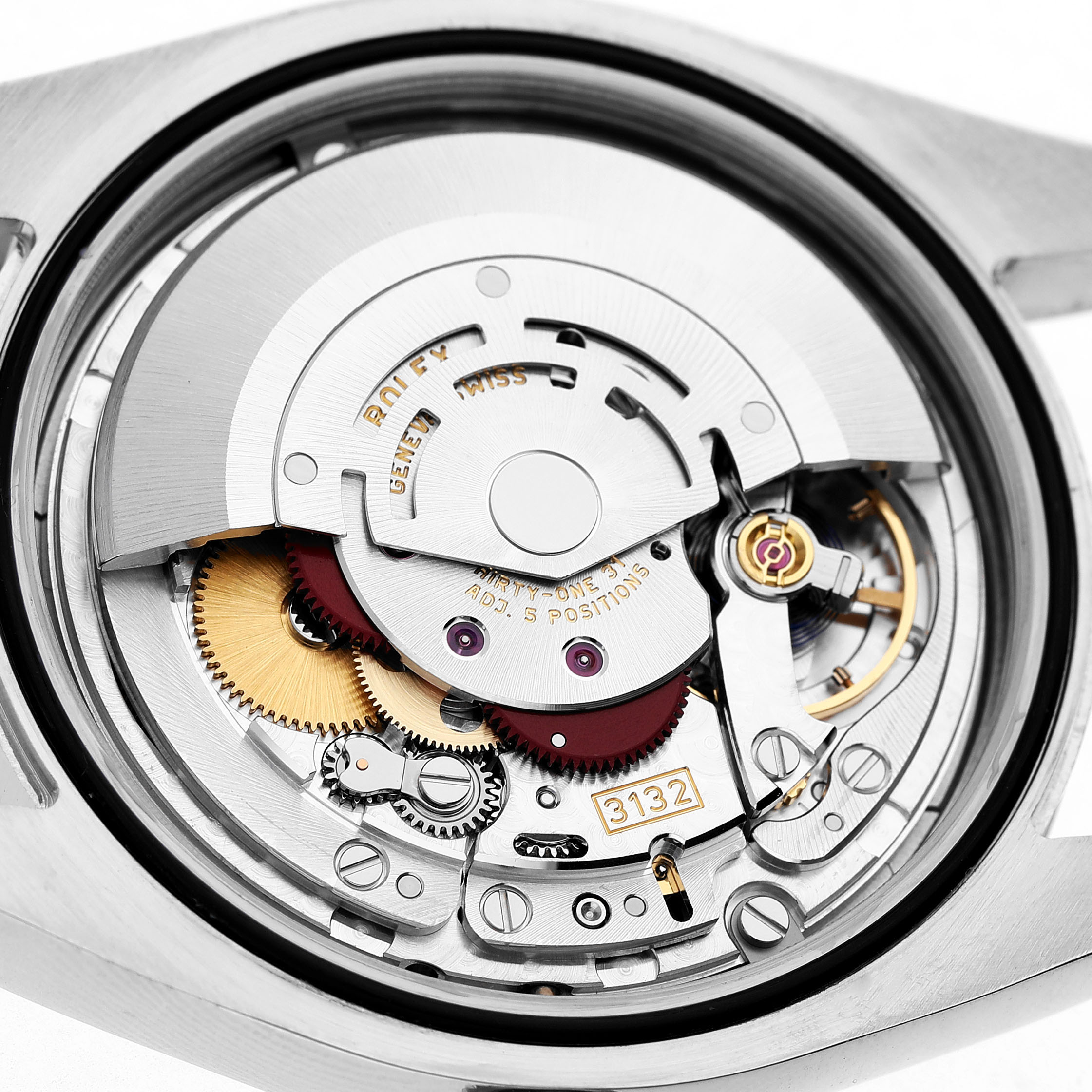 The image shows the movement of a Rolex Oyster Perpetual 114300 Men's Stainless Steel Silver Dial watch, highlighting gears and the rotor.