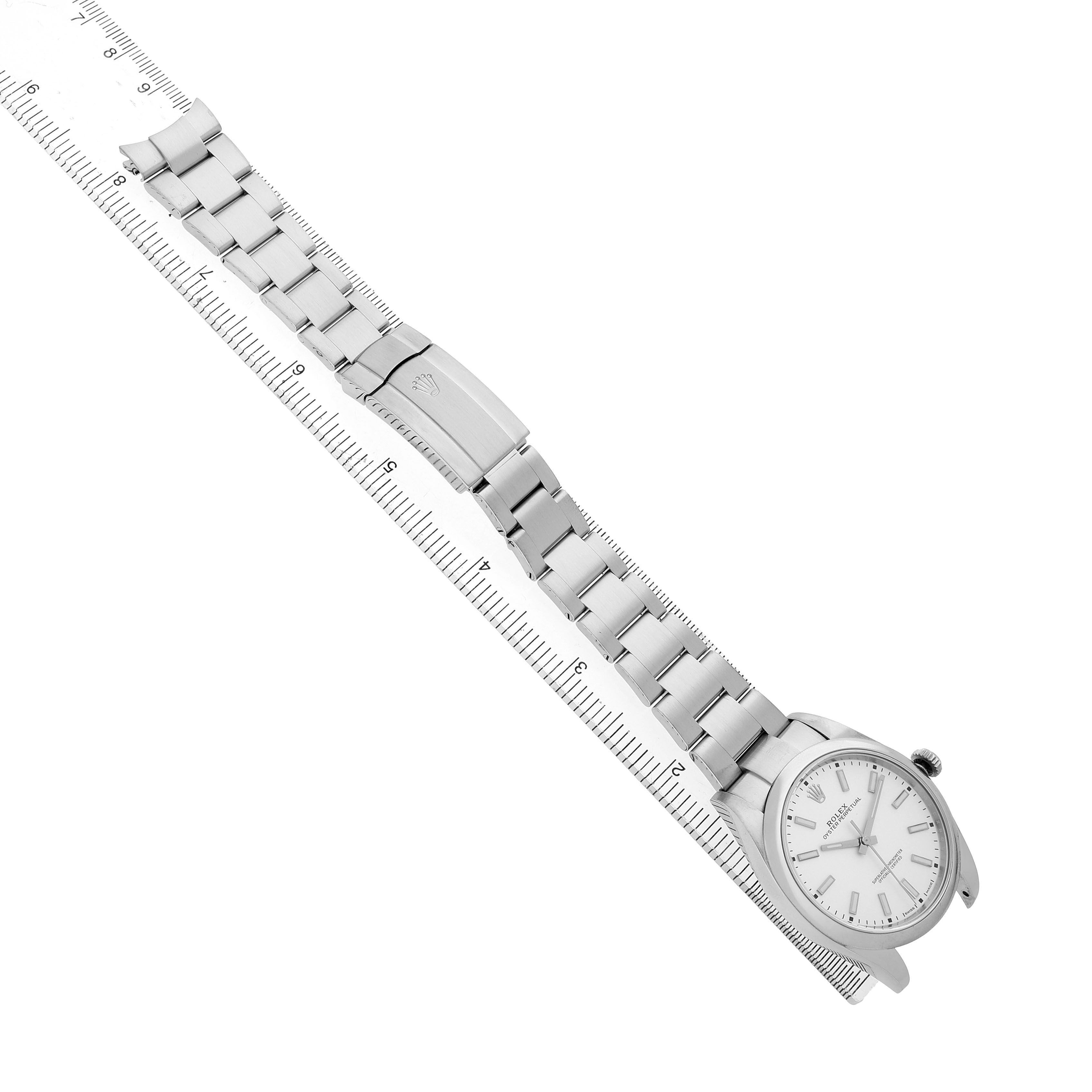 The Rolex Oyster Perpetual 114300 Men's Stainless Steel Silver Dial watch is displayed flat with the face and full bracelet visible alongside a ruler.