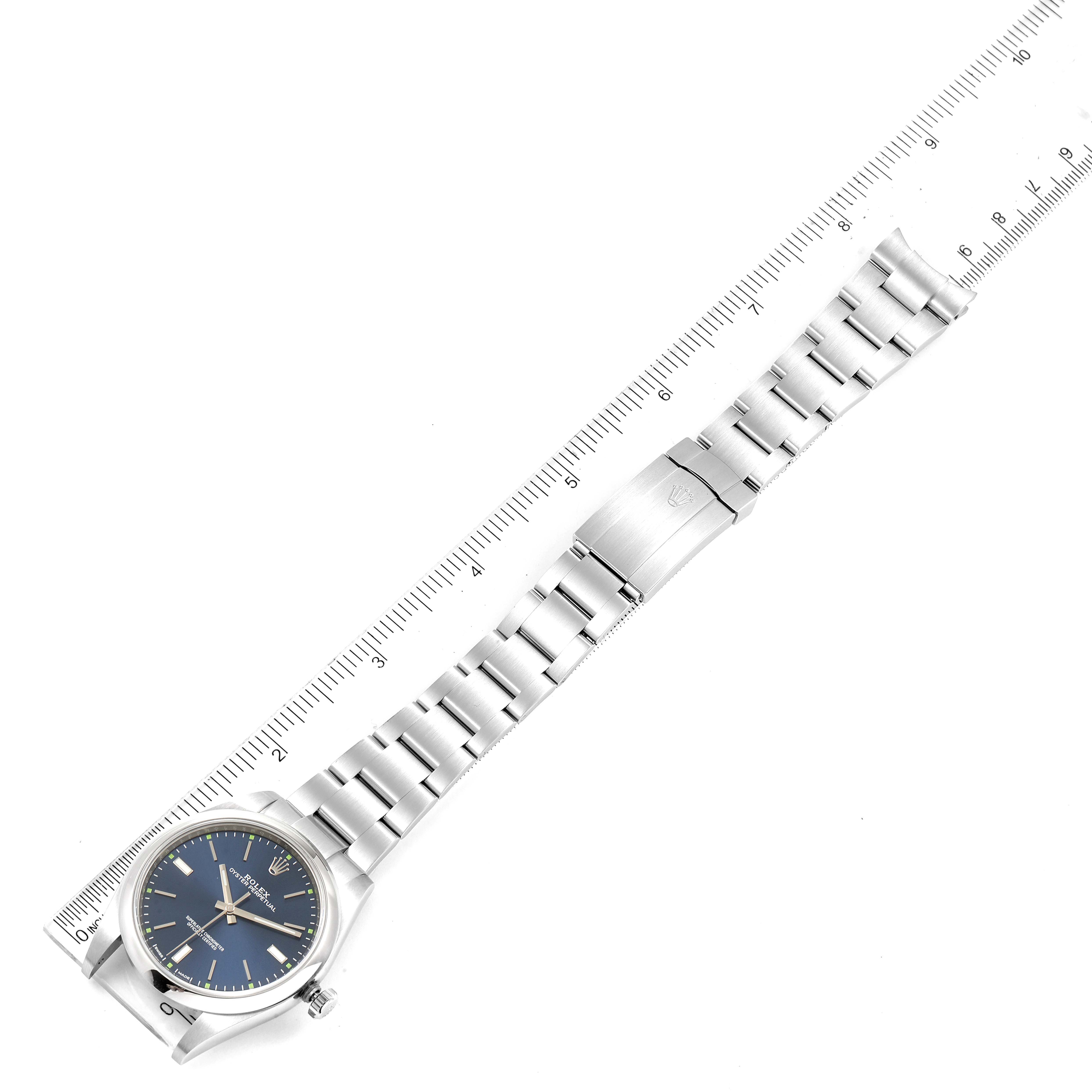 The image shows an overhead view of the Rolex Oyster Perpetual 114300 Men
s Stainless Steel Blue Dial 114300 Men
s Stainless Steel Blue Dial watch, highlighting its strap, clasp, and dial.