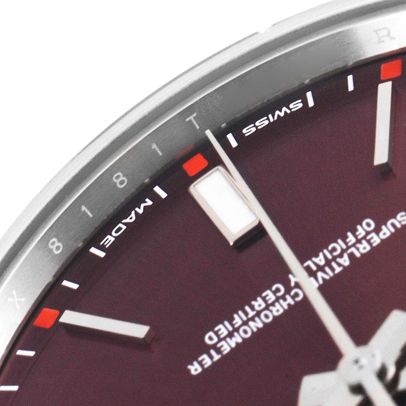 The close-up image shows the dial, hour markers, and part of the minute hand of a Rolex Oyster Perpetual 114300 Men's Stainless Steel Burgundy Dial 114300 Men's Stainless Steel Burgundy Dial watch.