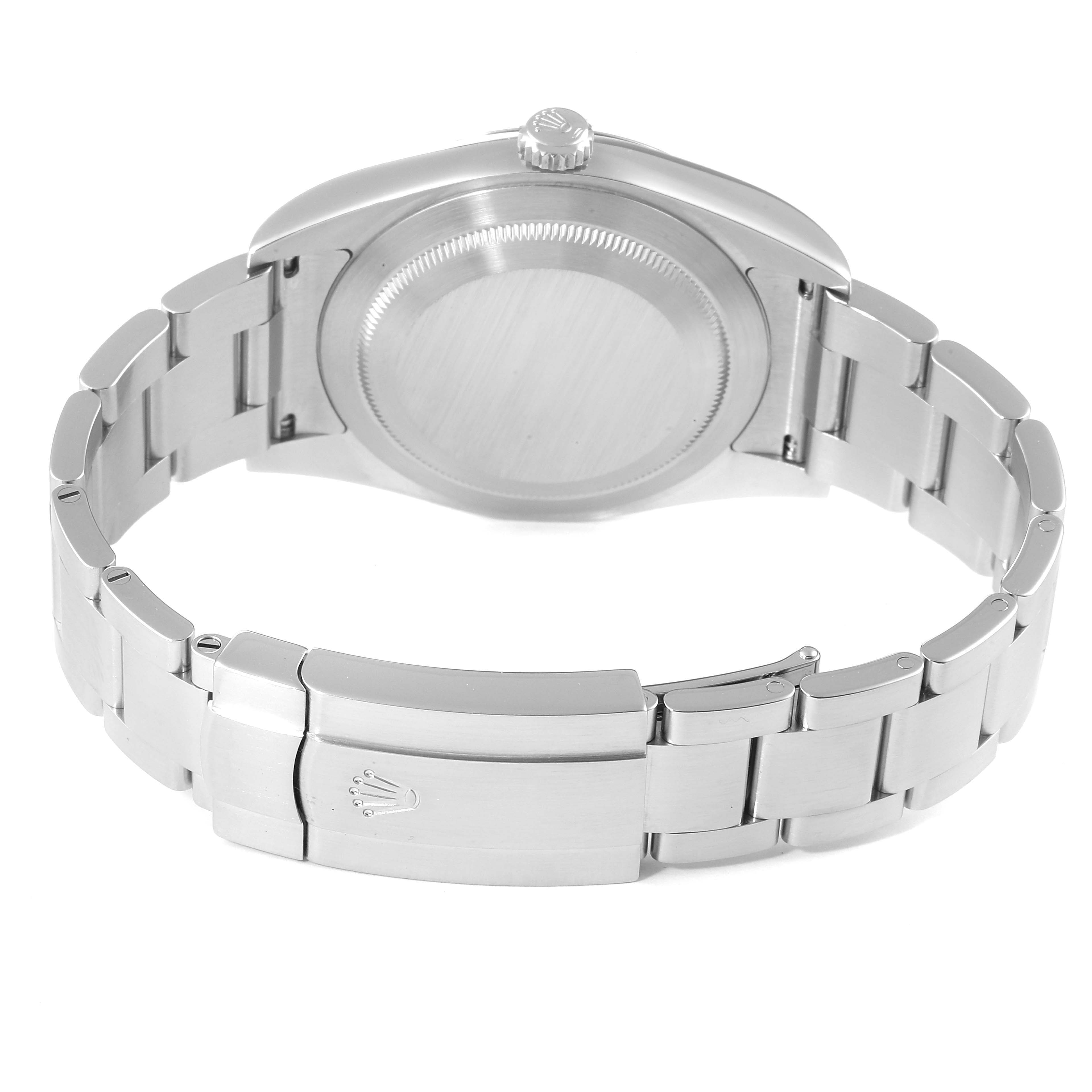 The image shows the back view of a Rolex Oyster Perpetual 114300 Men's Stainless Steel Burgundy Dial 114300 Men's Stainless Steel Burgundy Dial watch, including the case back, crown, and bracelet.