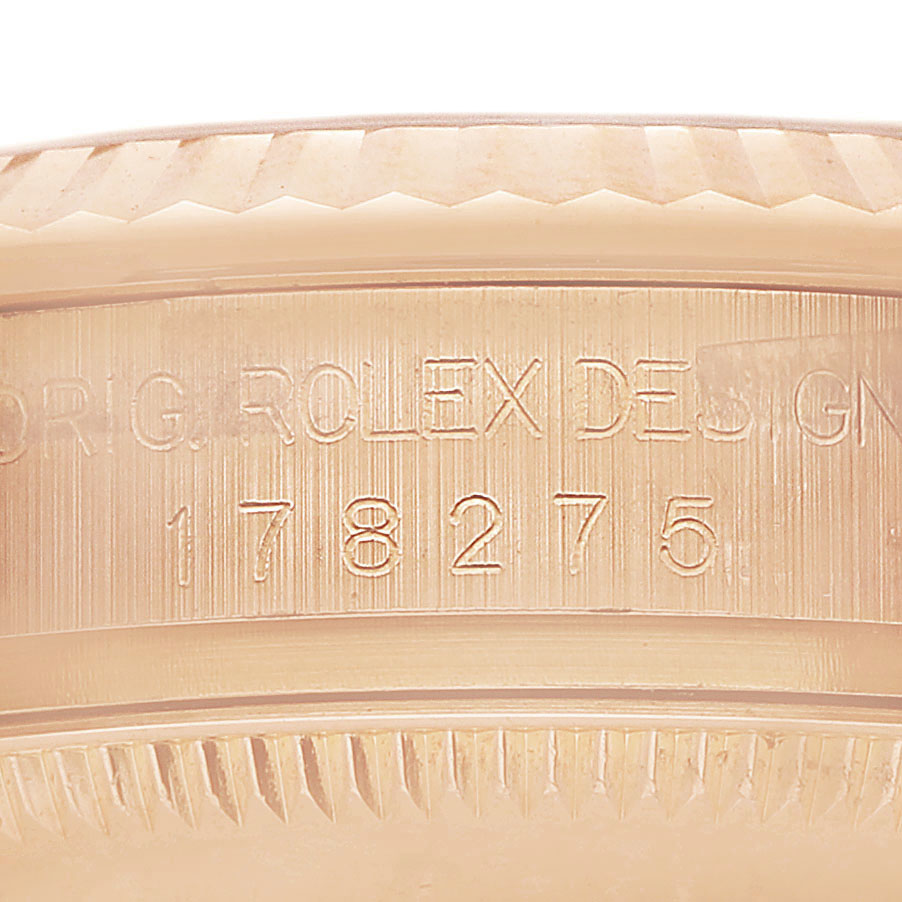 The image shows a close-up of the engraved case edge of a Rolex President 178275 Women's Rose Gold Pink Dial model watch.