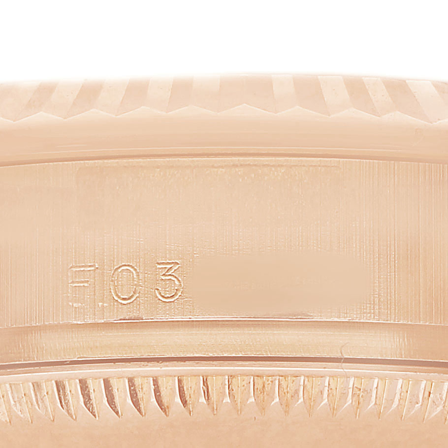 The image shows a close-up of the side of a Rolex President 178275 Women's Rose Gold Pink Dial watch case, highlighting the serial engraving.