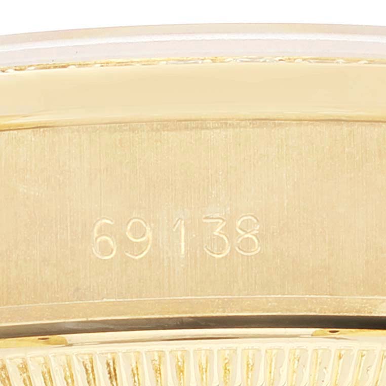 This image shows the side view of a Rolex President 69138 Women
s Yellow Gold Champagne Dial 69138 Women
s Yellow Gold Champagne Dial model watch with the reference number 69138 engraved on it.