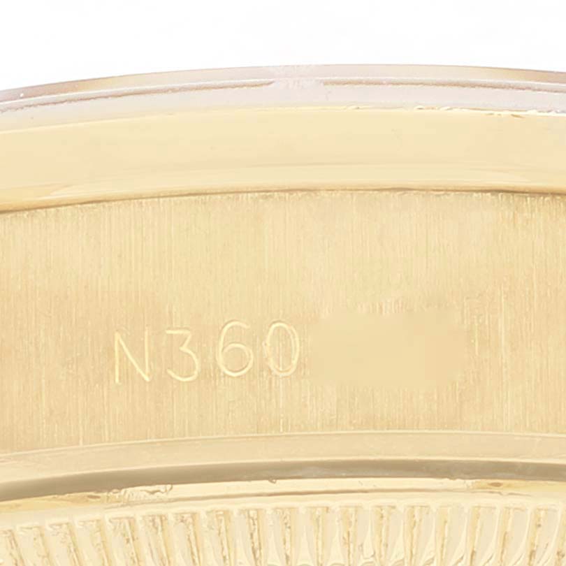 This close-up image shows the engraved serial number on the case back edge of a Rolex President 69138 Women
s Yellow Gold Champagne Dial 69138 Women
s Yellow Gold Champagne Dial model watch.