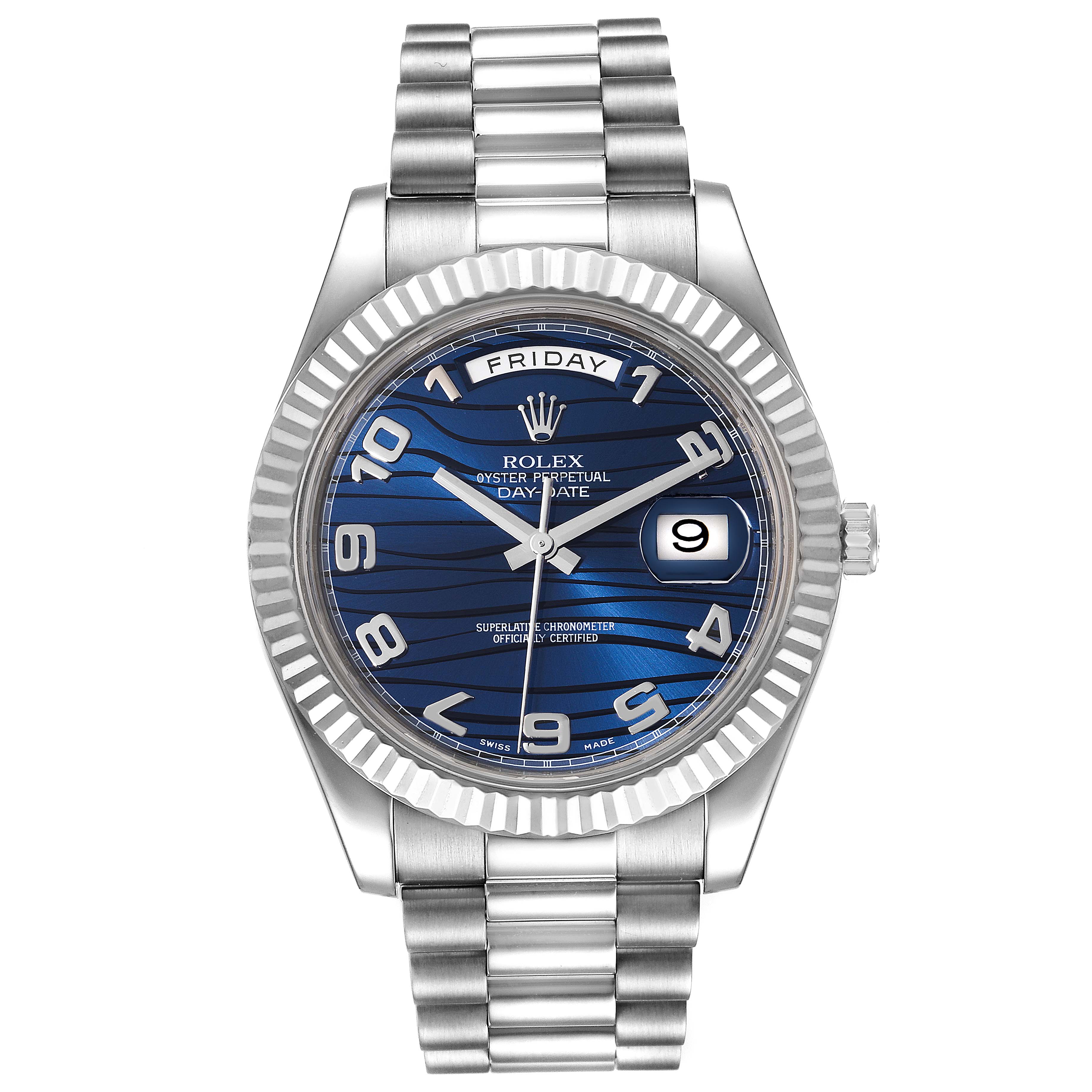 The image shows a front view of a Rolex President 218239 Men's White Gold Blue Dial 218239 Men's White Gold Blue Dial model watch, featuring its blue dial, date window, day display, and stainless steel bracelet.