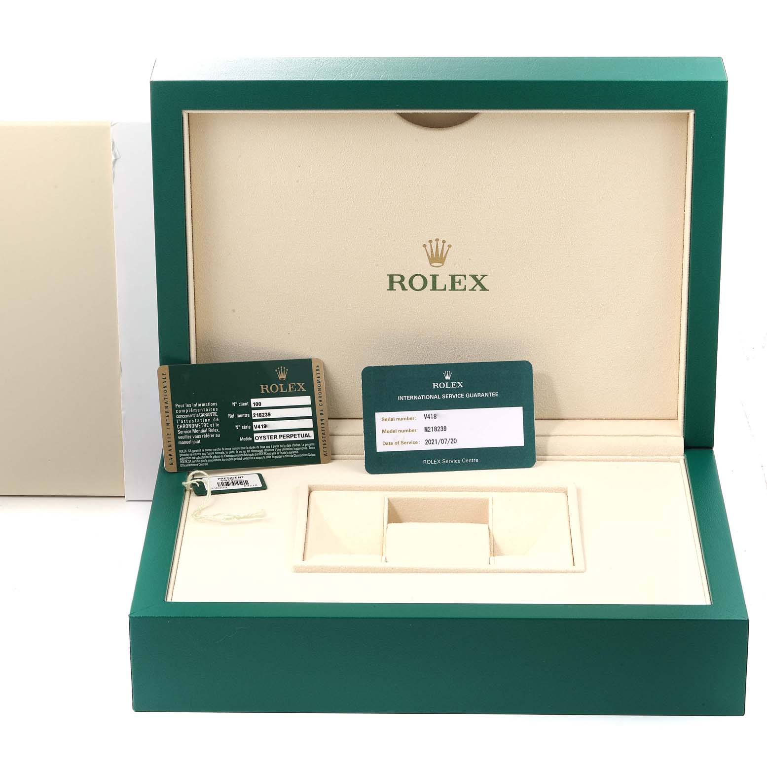 This image shows the box and accessories of a Rolex President 218239 Men's White Gold Blue Dial 218239 Men's White Gold Blue Dial model, including guarantee cards and a tag, viewed from the front.