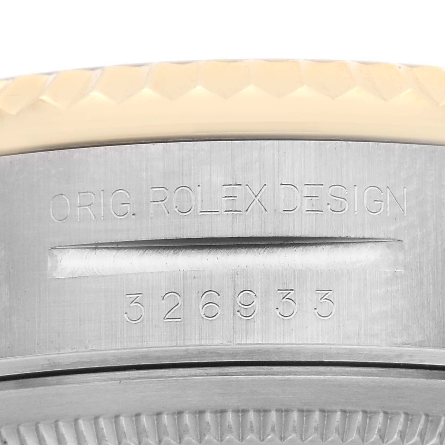 This close-up image shows the engraved side of a Rolex Sky-Dweller 326933 Men's Steel and Gold (two tone) White Dial 326933 Men's Steel and Gold (two tone) White Dial watch case with model details.