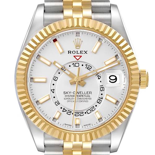 The Rolex Sky-Dweller watch is shown from a frontal angle, featuring its bezel, dial, hands, and date window.