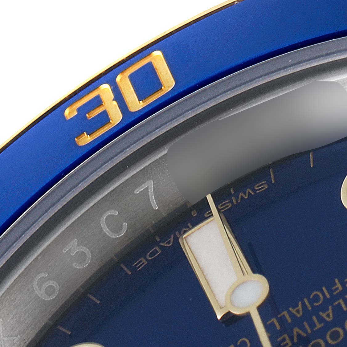 This image shows a close-up of the bezel and dial of a Rolex Submariner 116613 Men
s Steel and Gold (two tone) Blue Dial 116613 Men
s Steel and Gold (two tone) Blue Dial watch, focusing on the 30-minute mark.
