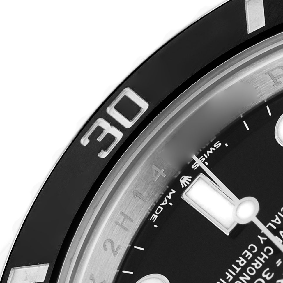 The image shows a close-up of the bezel and a portion of the dial of a Rolex Submariner 126610 Men's Stainless Steel Black Dial watch.