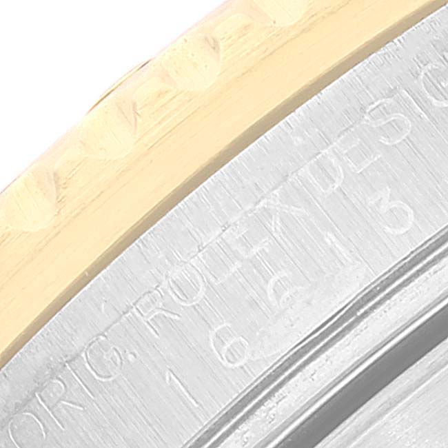 This close-up image shows the case back and part of the bezel of a Rolex Submariner 16613 Men's Steel and Gold (two tone) Black Dial 16613 Men's Steel and Gold (two tone) Black Dial watch, highlighting its engravings and metal textures.