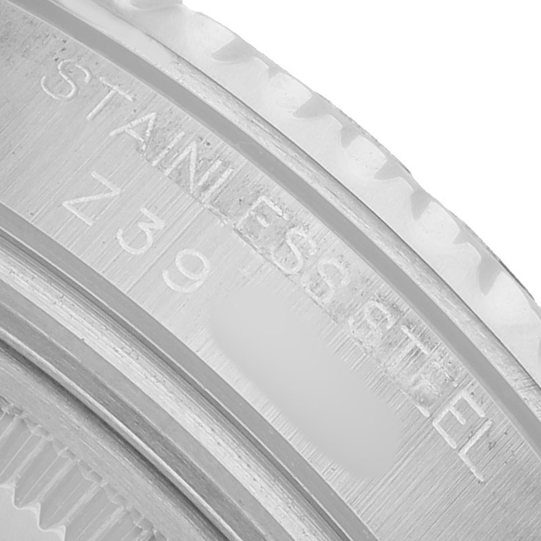 The image shows a close-up of the brushed stainless steel edge with engravings, likely the bezel edge of a Rolex Yacht-Master 168622 Men's Stainless Steel Silver Dial watch.