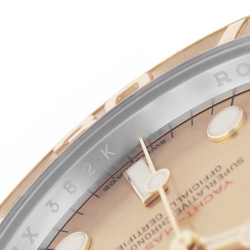 The image shows a close-up of the Rolex Yacht-Master 16623 Men's Stainless Steel Champagne Dial's bezel, part of the dial, and hour markers.