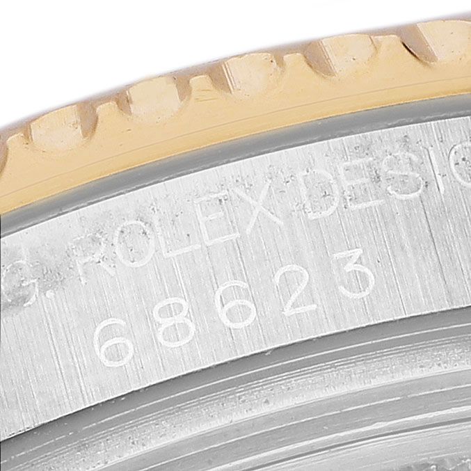 The image shows a close-up of the case side and bezel with engraved text on the Rolex Yacht-Master 68623 Men's Steel and Gold (two tone) Blue Dial watch.