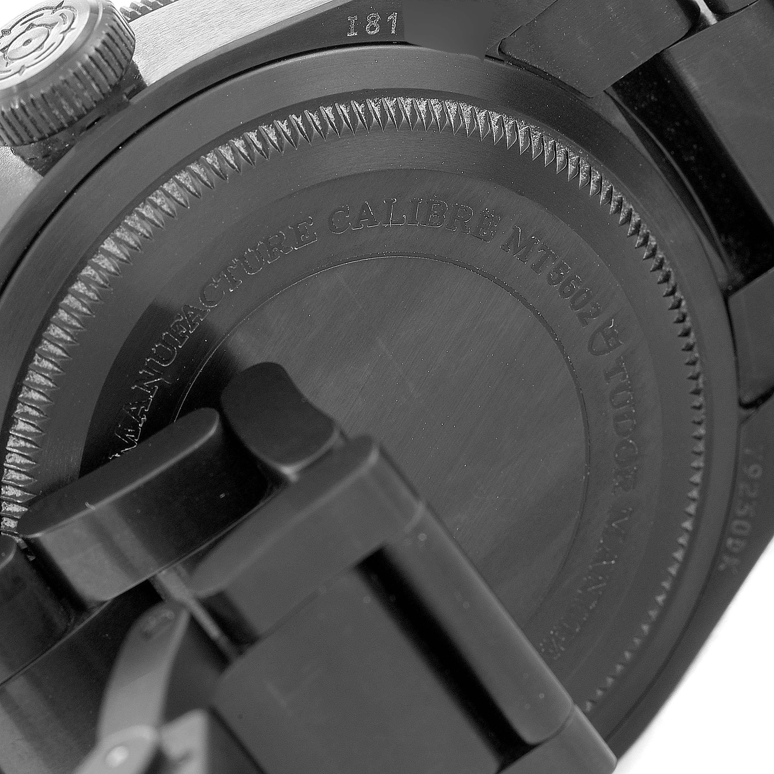 The image shows the back case and bracelet clasp of a Tudor Heritage Black Bay 79230DK Men's Stainless Steel Black Dial 79230DK Men's Stainless Steel Black Dial watch, showcasing the engraving details.