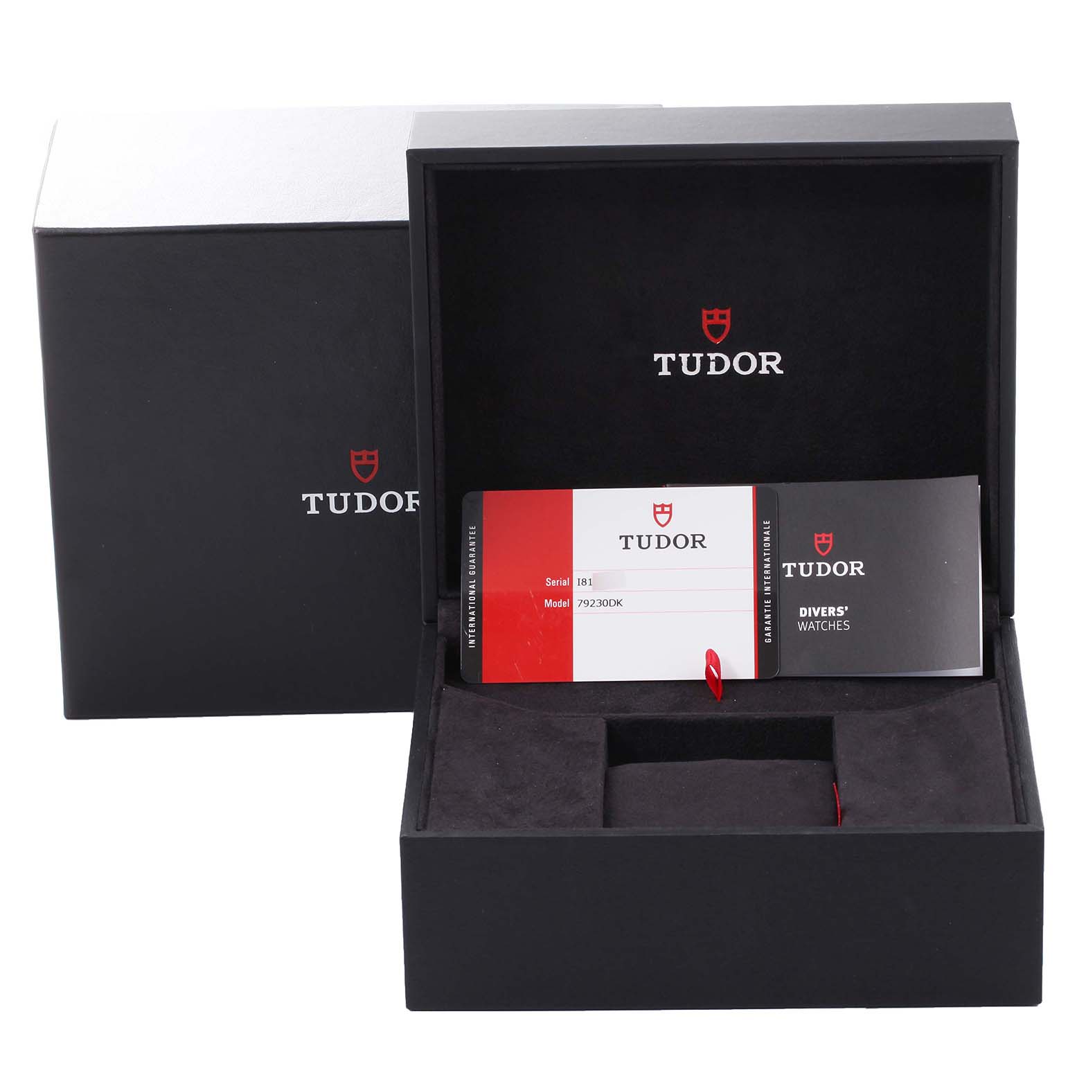 The image shows an open box for a Heritage Black Bay model by Tudor, displaying paperwork and an empty watch cushion.