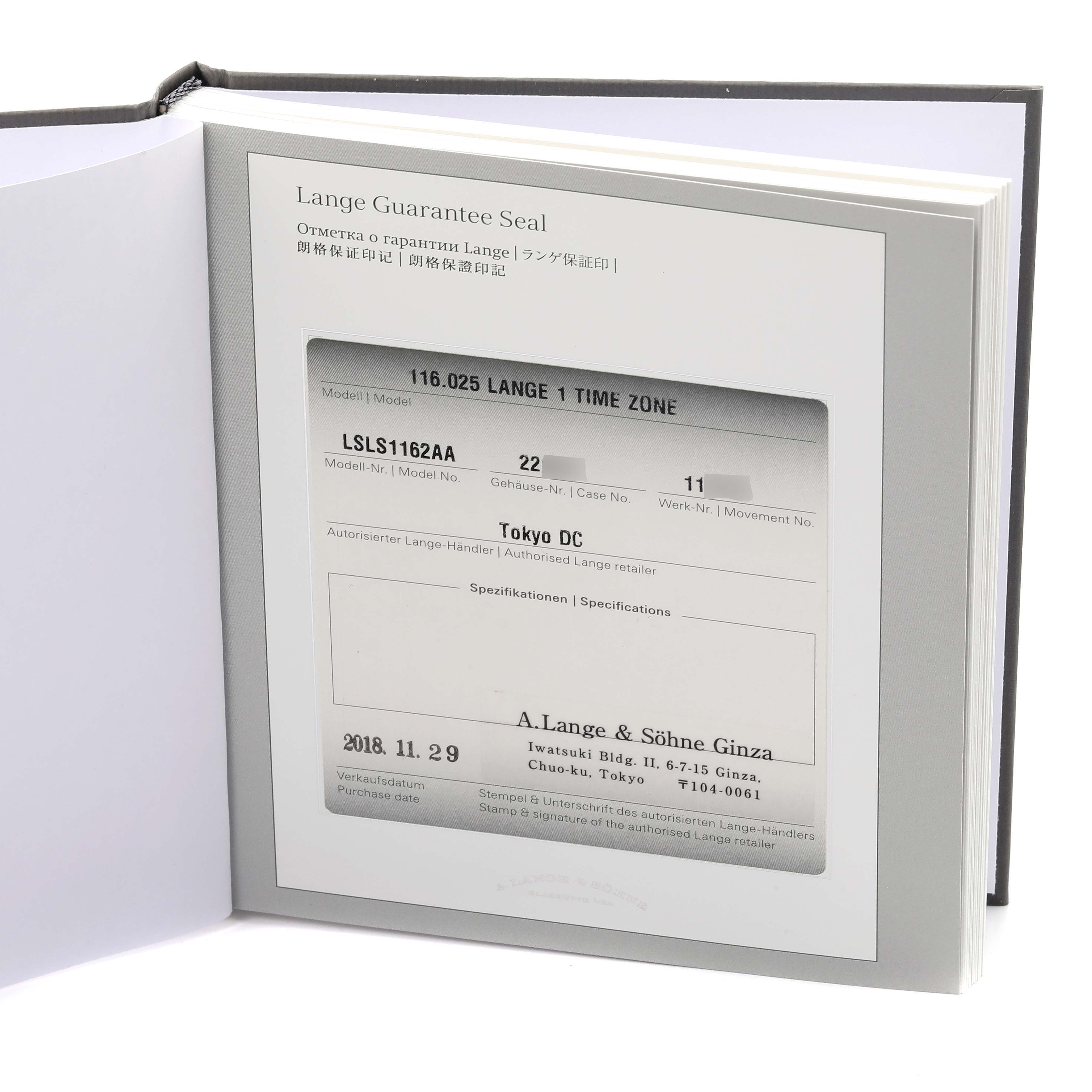 The image shows the warranty booklet for the A. Lange 
Sohne Lange 1 116.025 Men
s Platinum Silver Dial model at an angled view, displaying interior details.