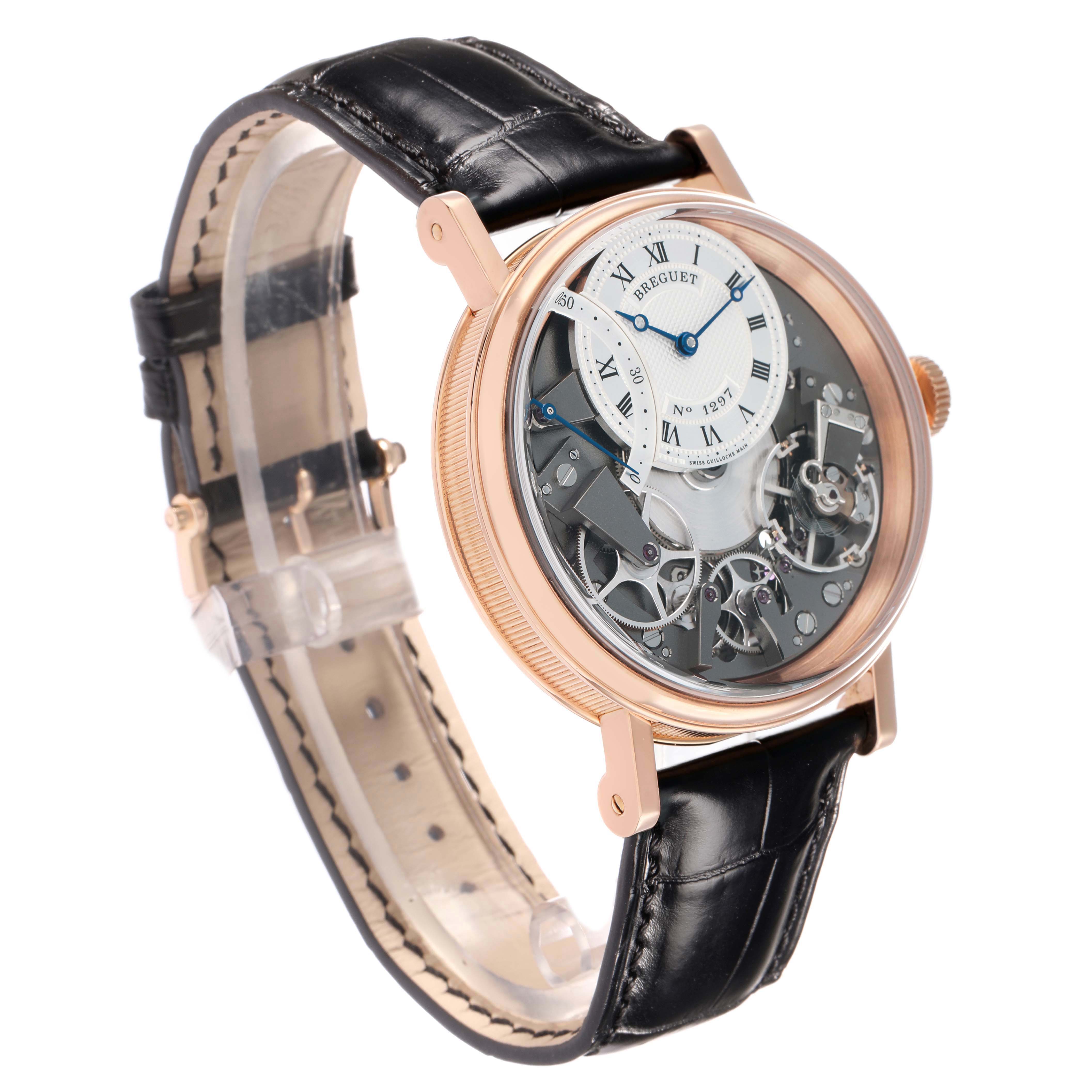 The Breguet Tradition 7097BR/G1/9WU Men
s Rose Gold Transparent Dial watch is shown at a three-quarter angle, highlighting its skeleton dial and black leather strap.