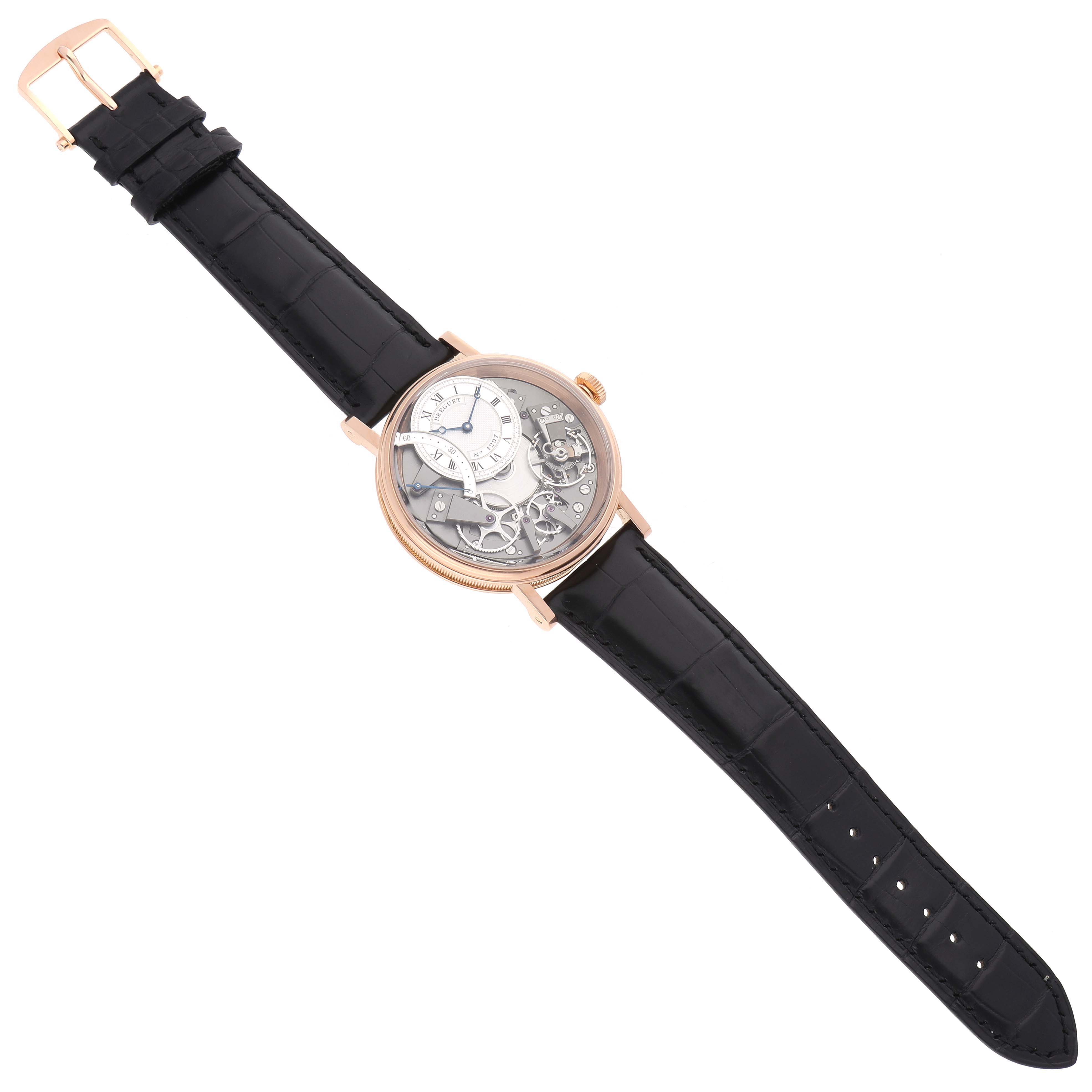 The Breguet Tradition 7097BR/G1/9WU Men
s Rose Gold Transparent Dial watch is shown at a slight angle, displaying its detailed openwork dial and black leather strap.