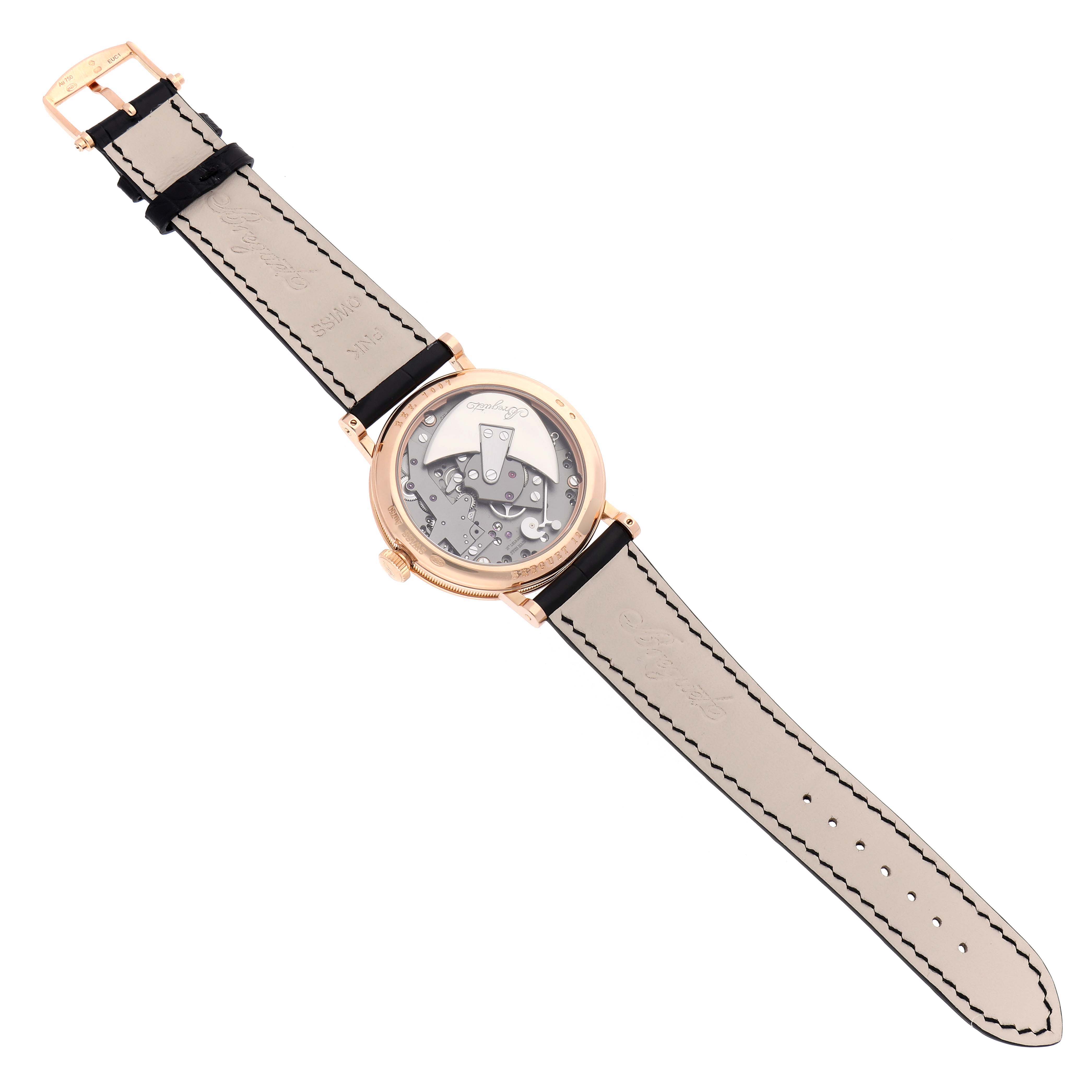 The Breguet Tradition 7097BR/G1/9WU Men
s Rose Gold Transparent Dial watch is shown from the back view, displaying its intricate movement and leather strap.