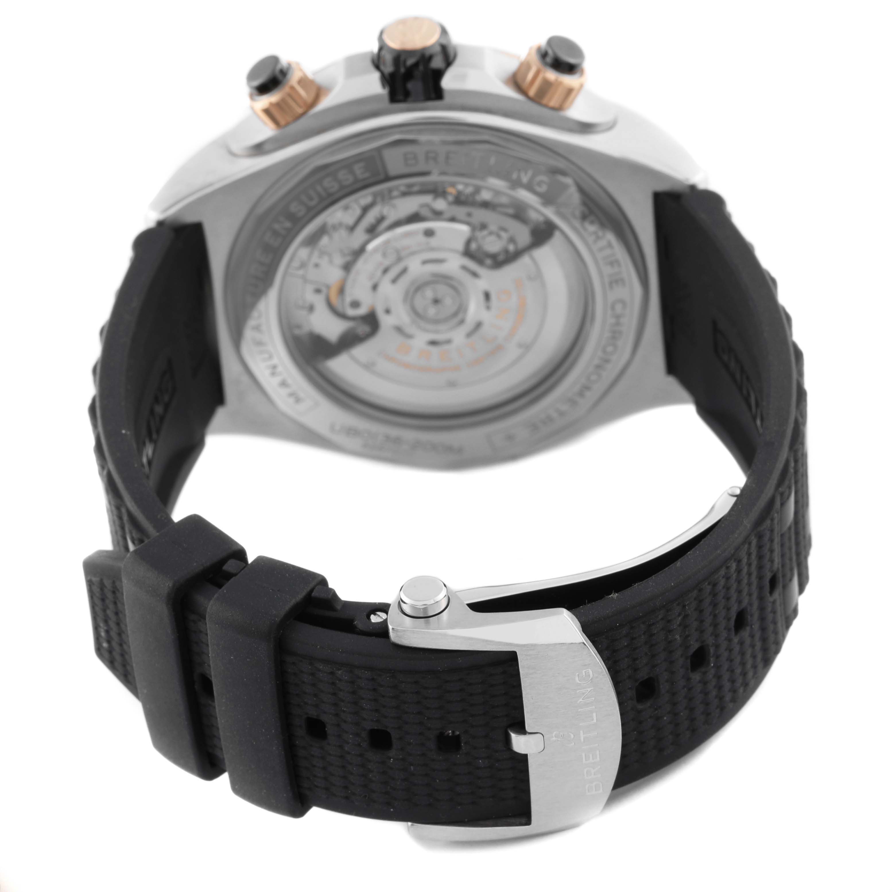 The Breitling Chronomat UB0136 Men's Stainless Steel Green Dial UB0136 Men's Stainless Steel Green Dial watch is shown from the back, highlighting the open case back and black rubber strap.