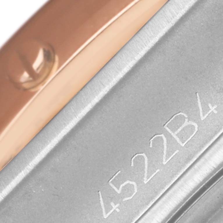 The image shows a close-up of the side of a Breitling Chronomat UB0136 Men's Stainless Steel Green Dial UB0136 Men's Stainless Steel Green Dial watch, highlighting its bezel and engraved serial number.