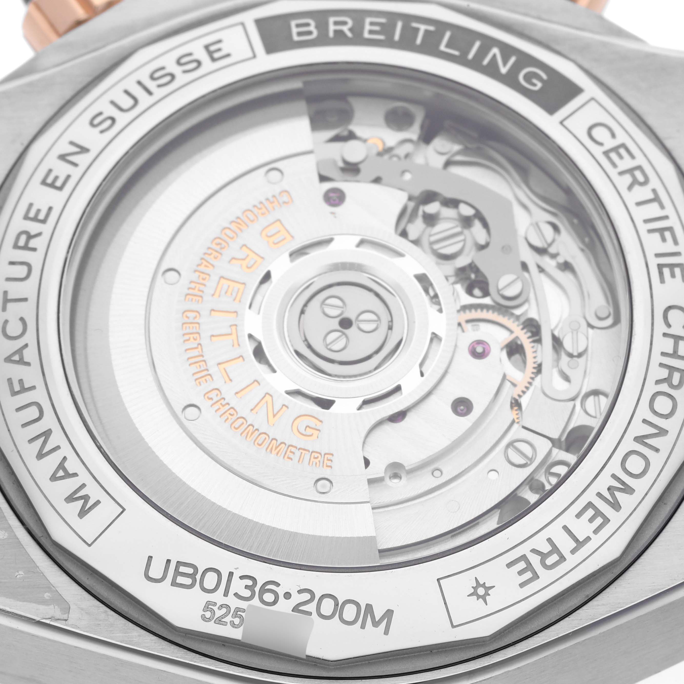 The image shows the back view of a Breitling Chronomat UB0136 Men's Stainless Steel Green Dial UB0136 Men's Stainless Steel Green Dial watch, highlighting its transparent case back and the internal mechanism.