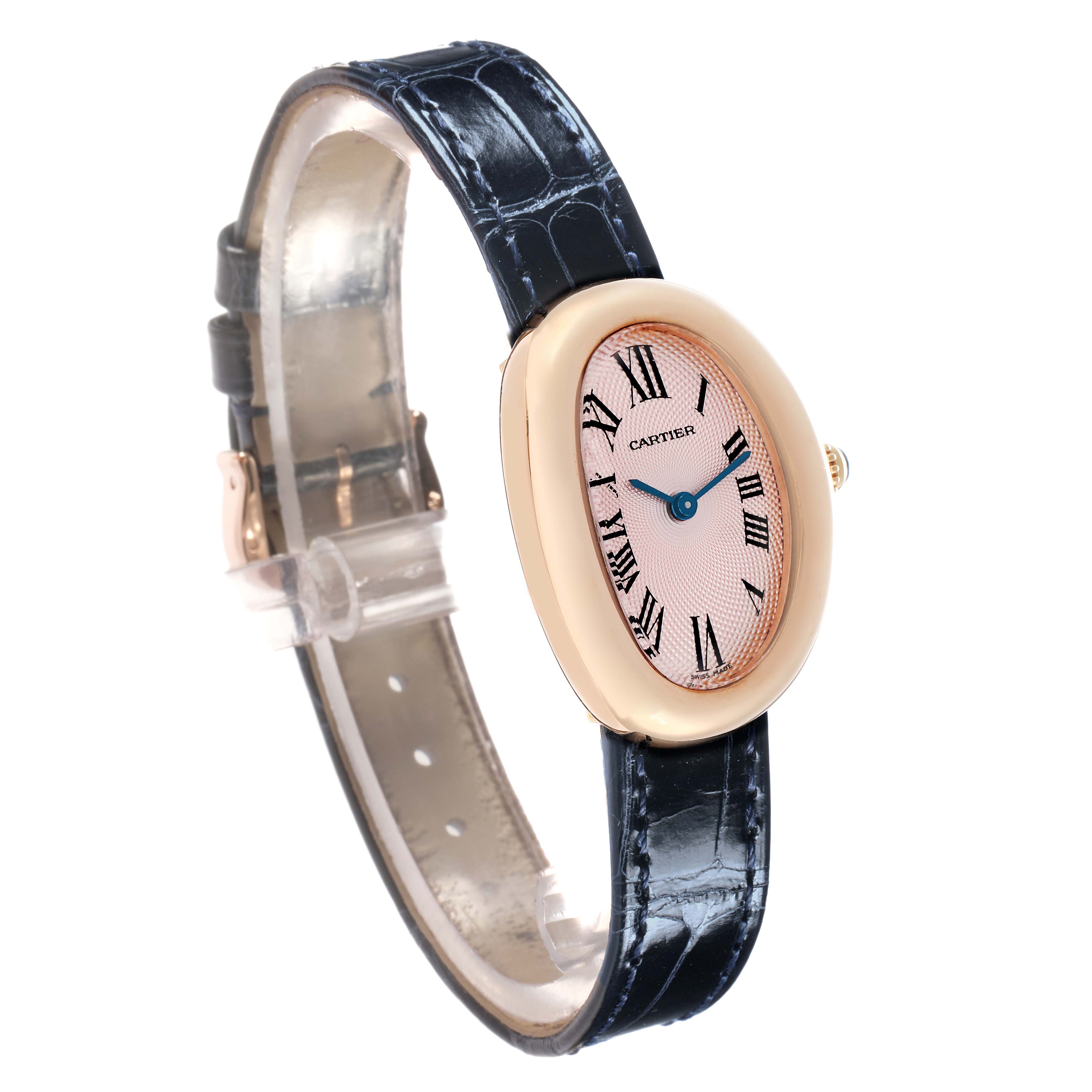 The Cartier Baignoire W1544956 Women
s Rose Gold Pink Dial watch is shown at a side angle, highlighting the oval case, Roman numeral dial, blue hands, and leather strap.
