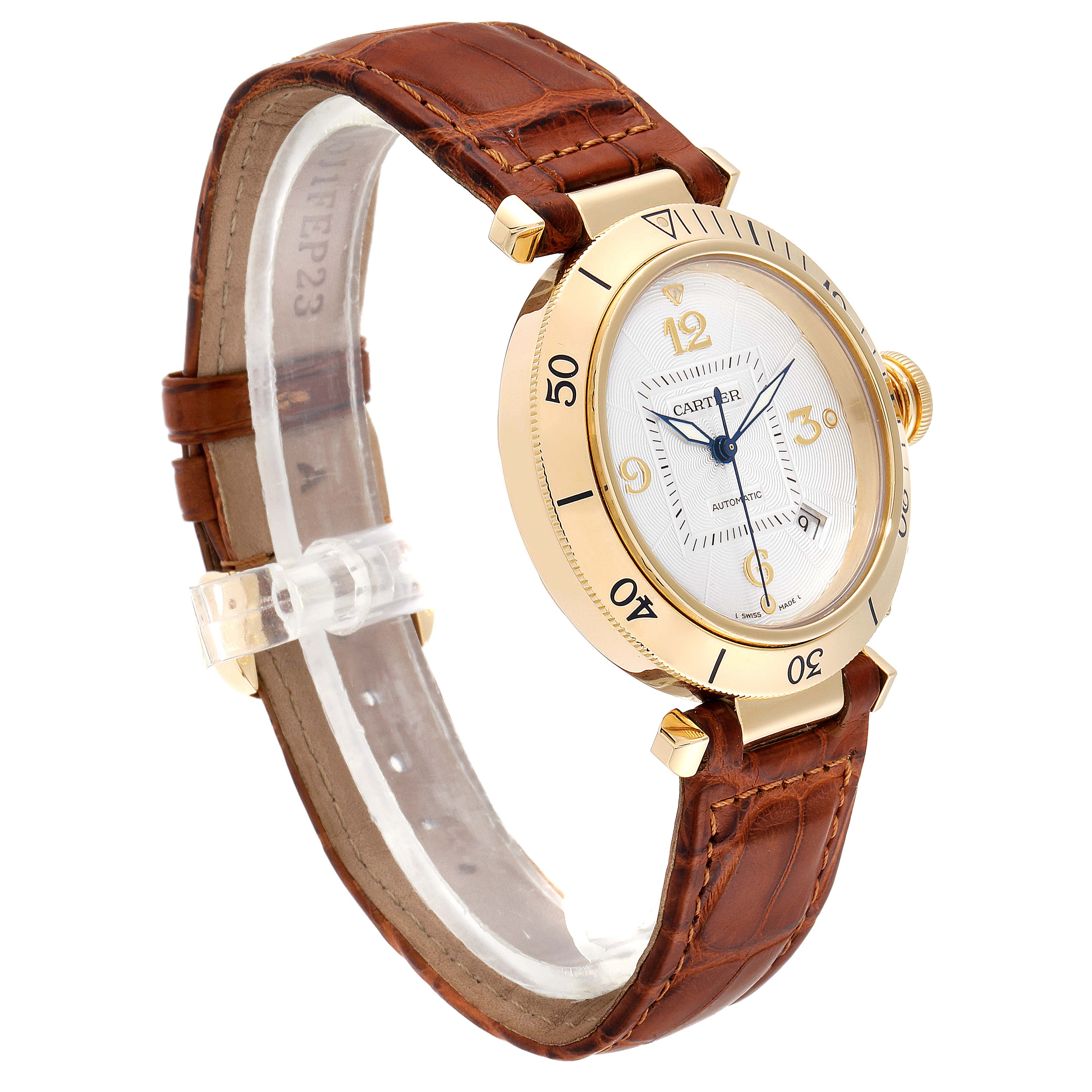 The image shows a Cartier Pasha W3004856 Men's Yellow Gold Silver Dial W3004856 Men's Yellow Gold Silver Dial model watch at an oblique angle, focusing on the face, bezel, and leather strap.