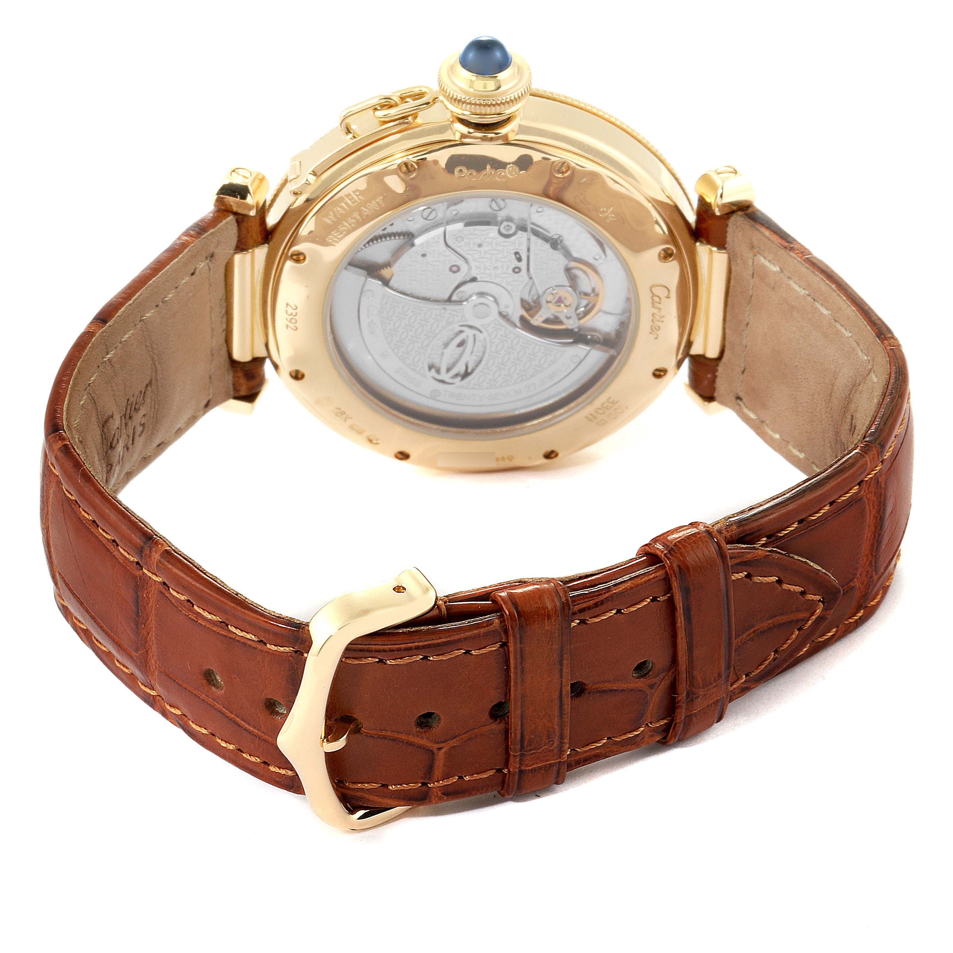 The image shows the back view of a Cartier Pasha W3004856 Men's Yellow Gold Silver Dial W3004856 Men's Yellow Gold Silver Dial watch, highlighting the mechanical movement and brown leather strap.
