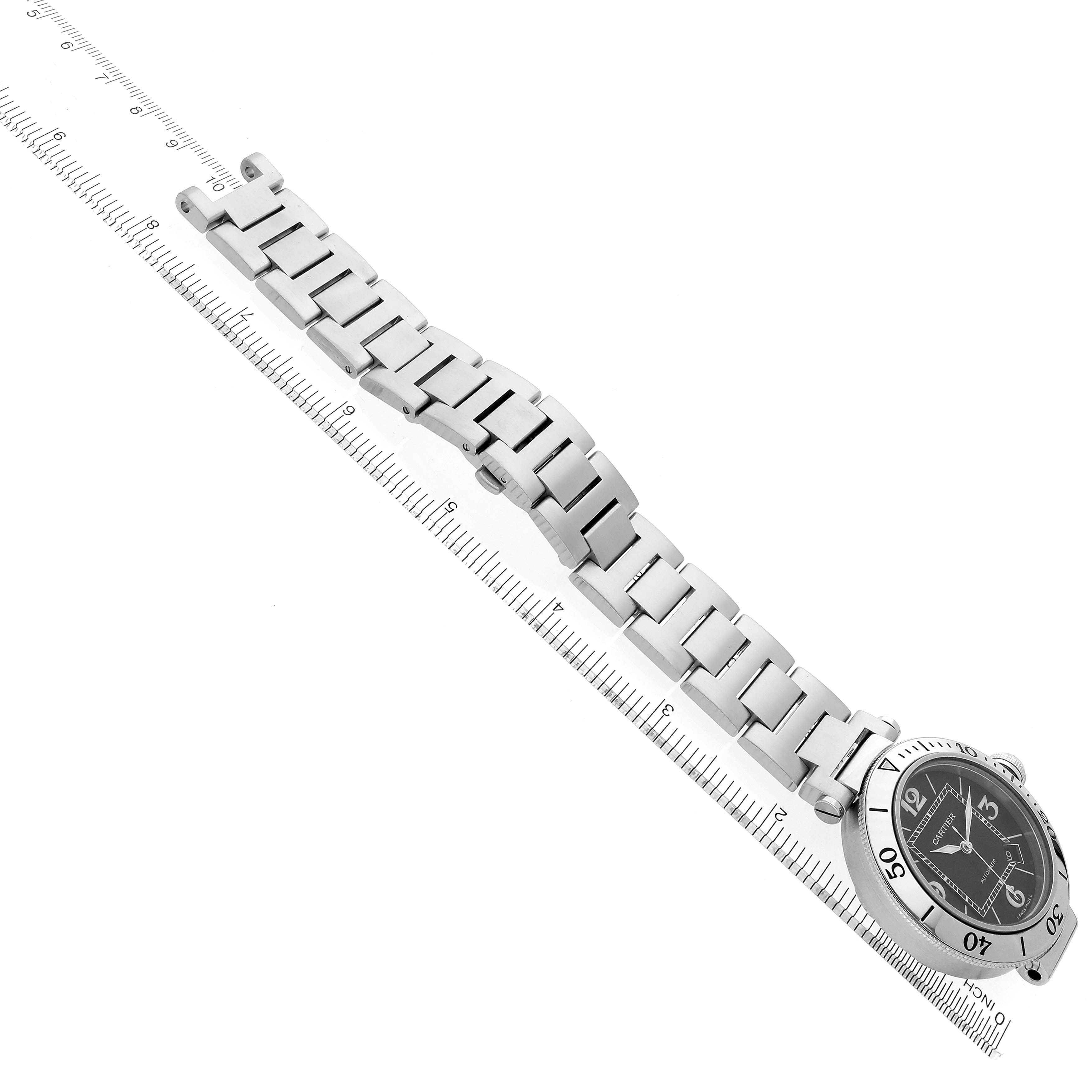 The Cartier Pasha W31077M7 Men
s Stainless Steel Black Dial W31077M7 Men
s Stainless Steel Black Dial watch is shown at an angle highlighting its face and full metal bracelet against a ruler.