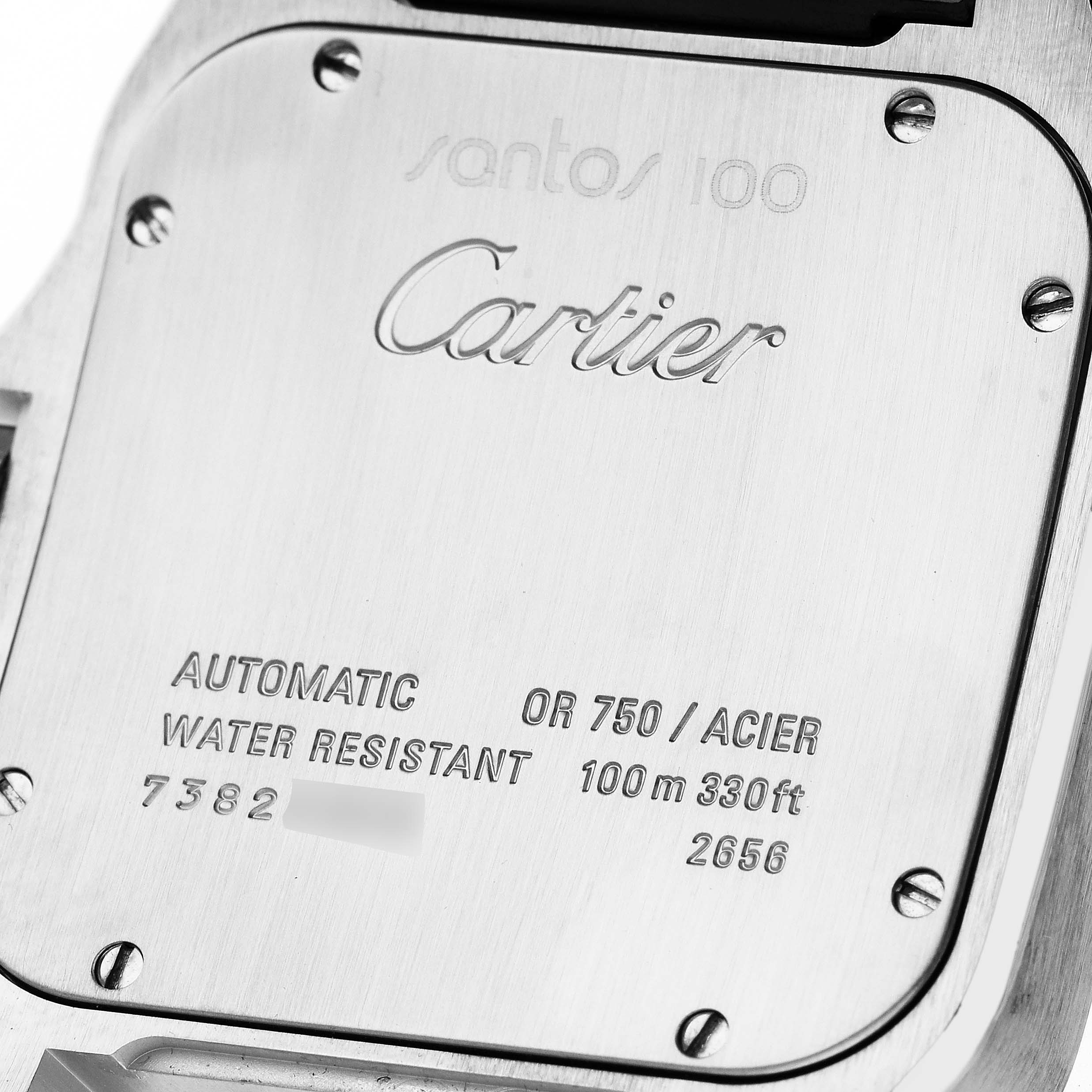 The image shows the back case of a Cartier Santos W20072X7 Men
s Steel and Gold (two tone) Silver Dial W20072X7 Men
s Steel and Gold (two tone) Silver Dial 100 watch, highlighting its inscriptions and screws.