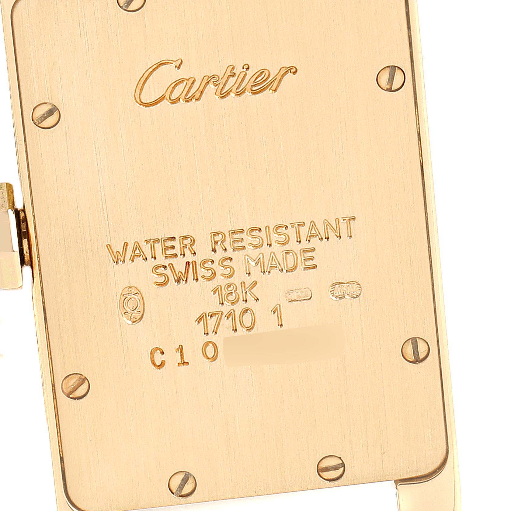 This image shows the back casing of the Cartier Tank Américaine watch, highlighting its engravings and screws.