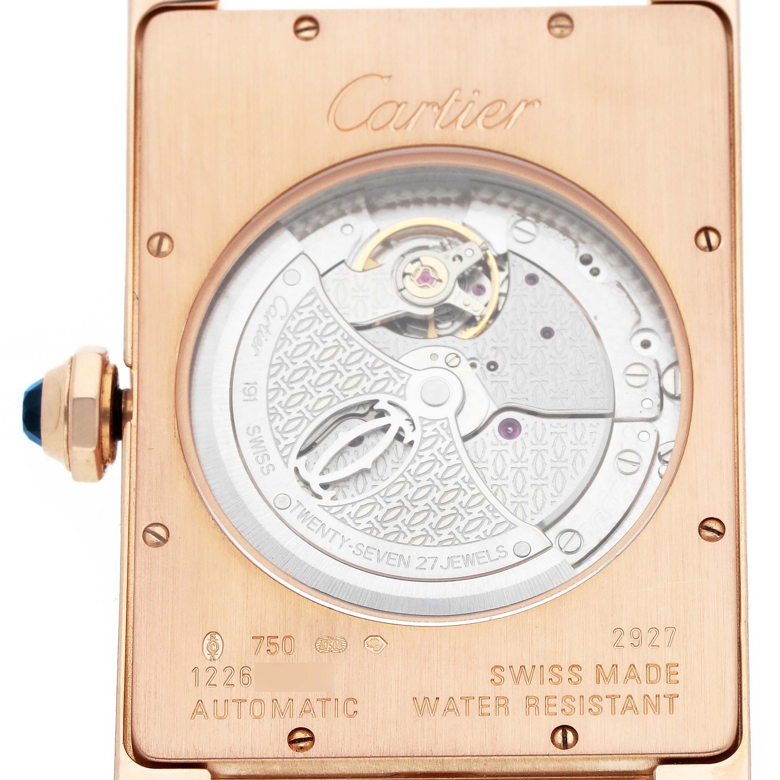 The image shows the back of the Cartier Tank Americaine W2609856 Men
s Rose Gold Silver Dial watch, highlighting its automatic movement and inscription details.