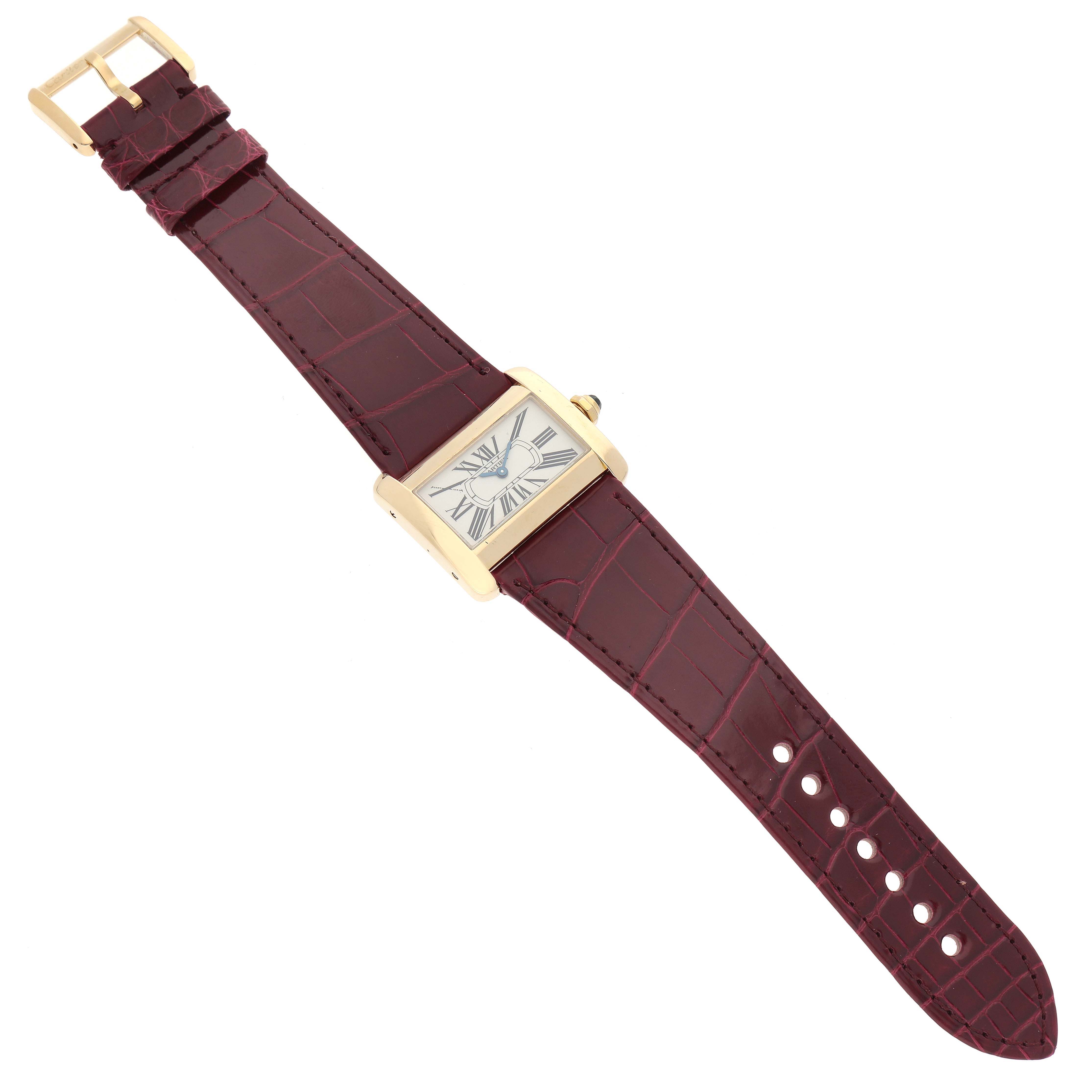 The Cartier Tank Divan W6300356 Women's Yellow Gold Silver Dial W6300356 Women's Yellow Gold Silver Dial watch is shown from a top view, displaying the face, burgundy strap, and gold buckle.